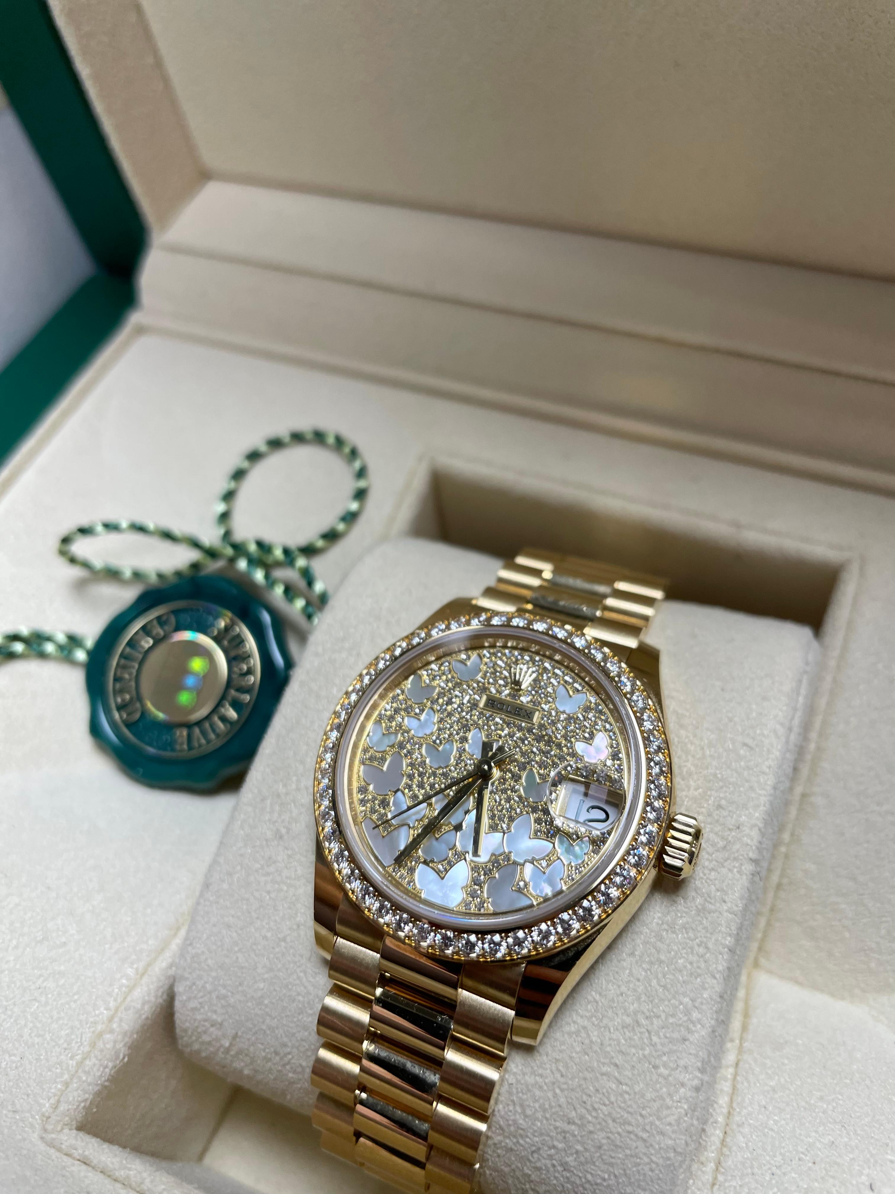 RARE Rolex Datejust watch size 31mm. 18kt Yellow Gold Case, Bezel Set With 46 Diamonds. Diamond Paved Mother-Of-Pearl Butterfly Dial. 18K yellow gold President bracelet with semi-circular three-piece links, concealed folding Crownclasp buckle.