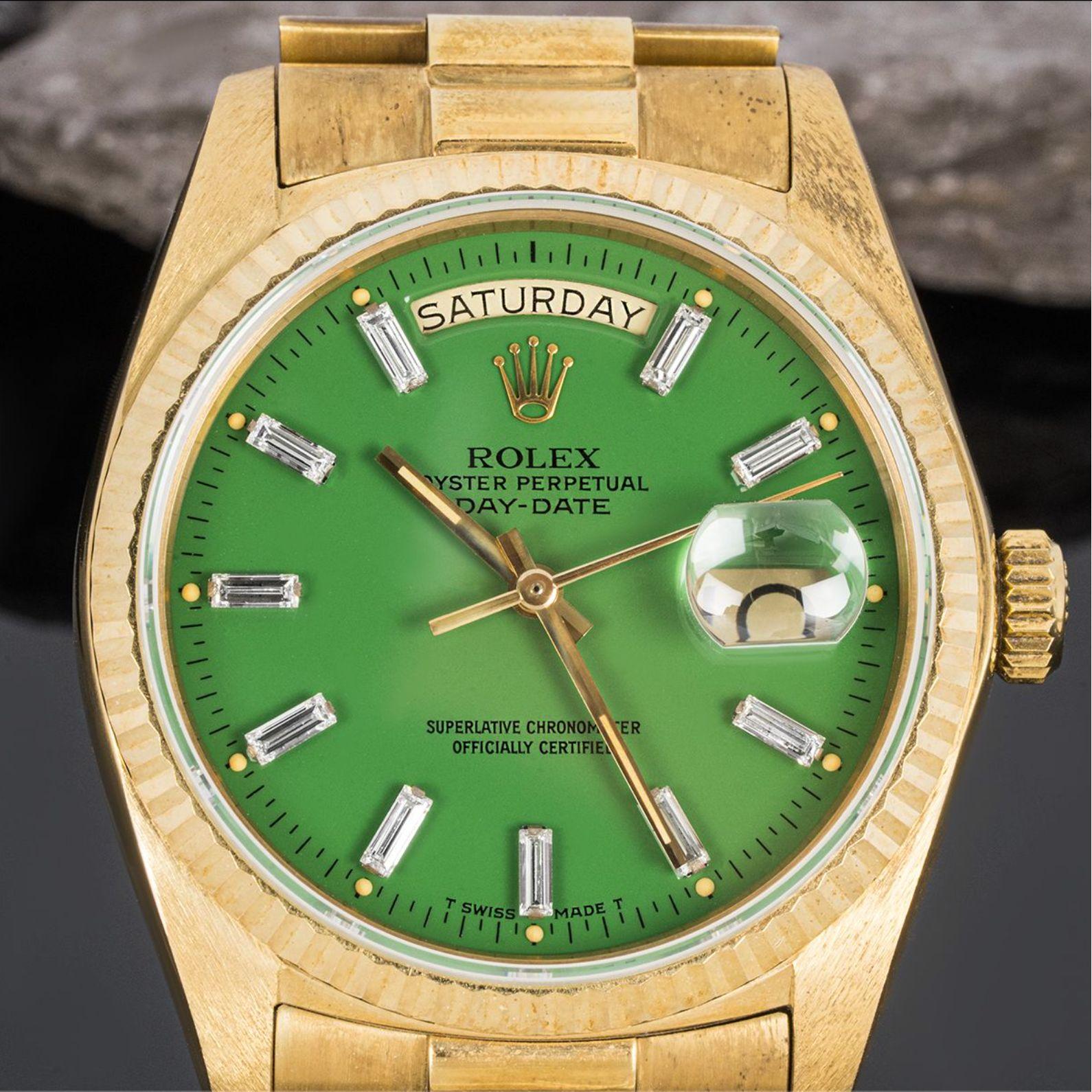 A rare NOS yellow gold Day-Date by Rolex. Featuring a stunning green Stella dial with emerald cut diamond hour markers and a fixed yellow gold fluted bezel.

Fitted with a sapphire glass, a self-winding automatic movement and a yellow gold president