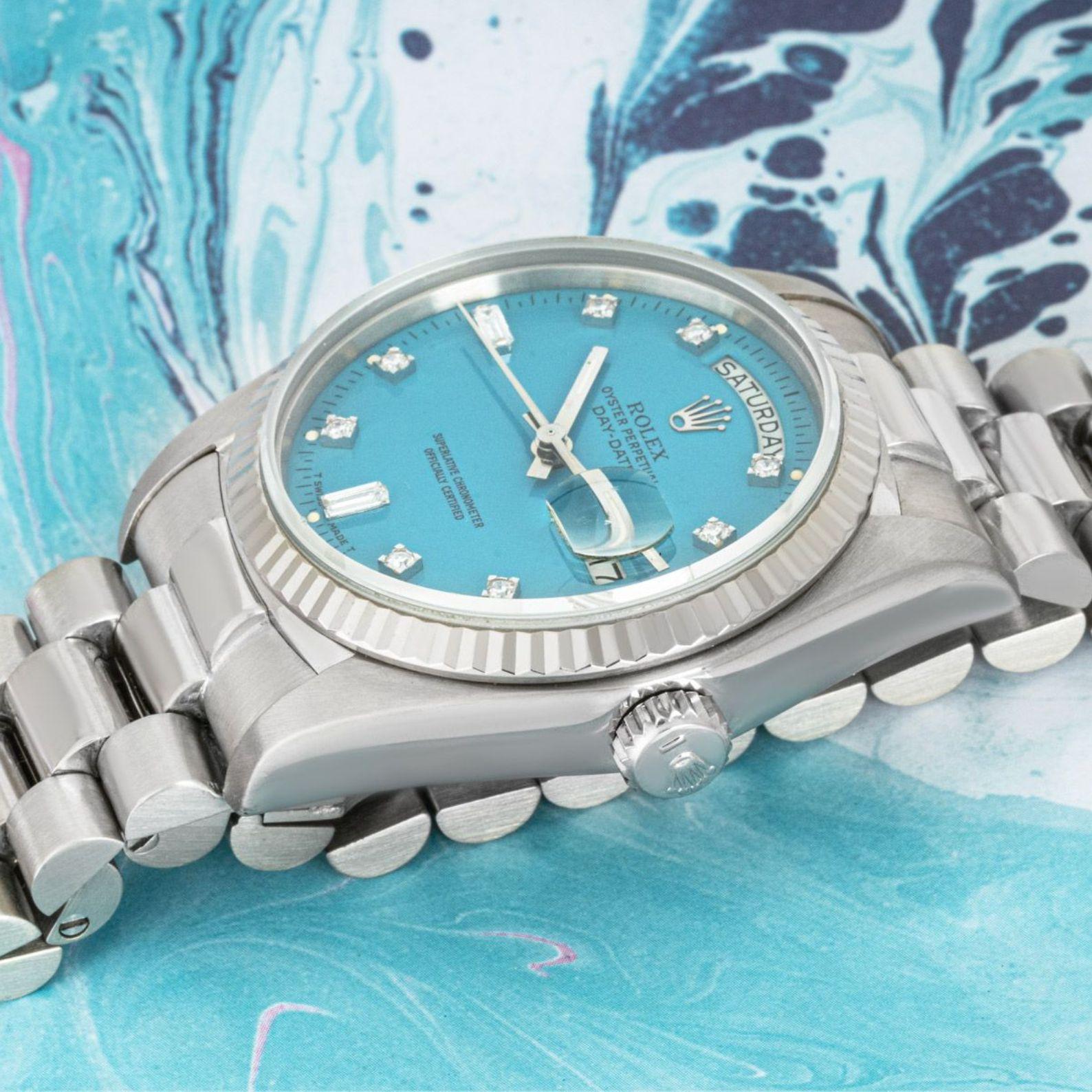A rare 36mm Day-Date crafted in white gold by Rolex. Featuring a stunning turquoise Stella dial set with 8 single cut diamonds as well as 2 baguette cut diamond hour markers and a fixed white gold fluted bezel.

Fitted with a sapphire glass, a