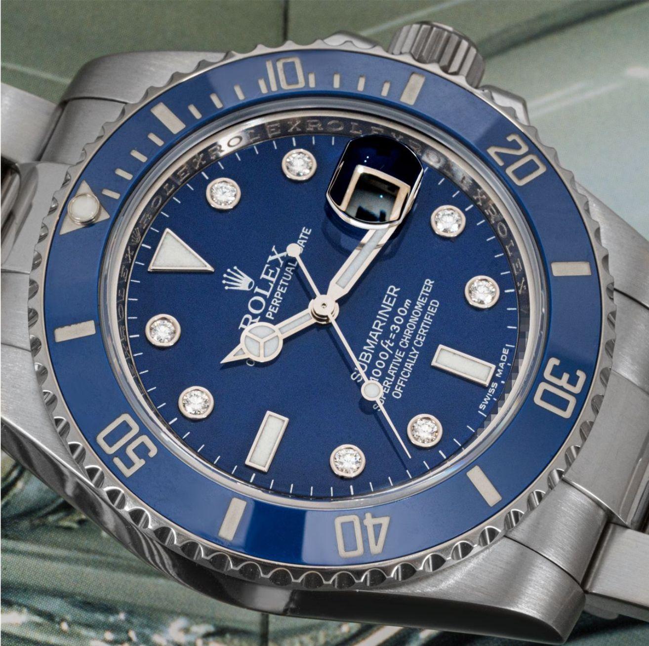 A white gold Submariner Date Smurf by Rolex. Featuring a blue dial with diamond set hour markers and a blue ceramic unidirectional rotatable bezel with 60-minute graduations. The Oyster bracelet comes with a folding Oysterlock clasp. Fitted with a