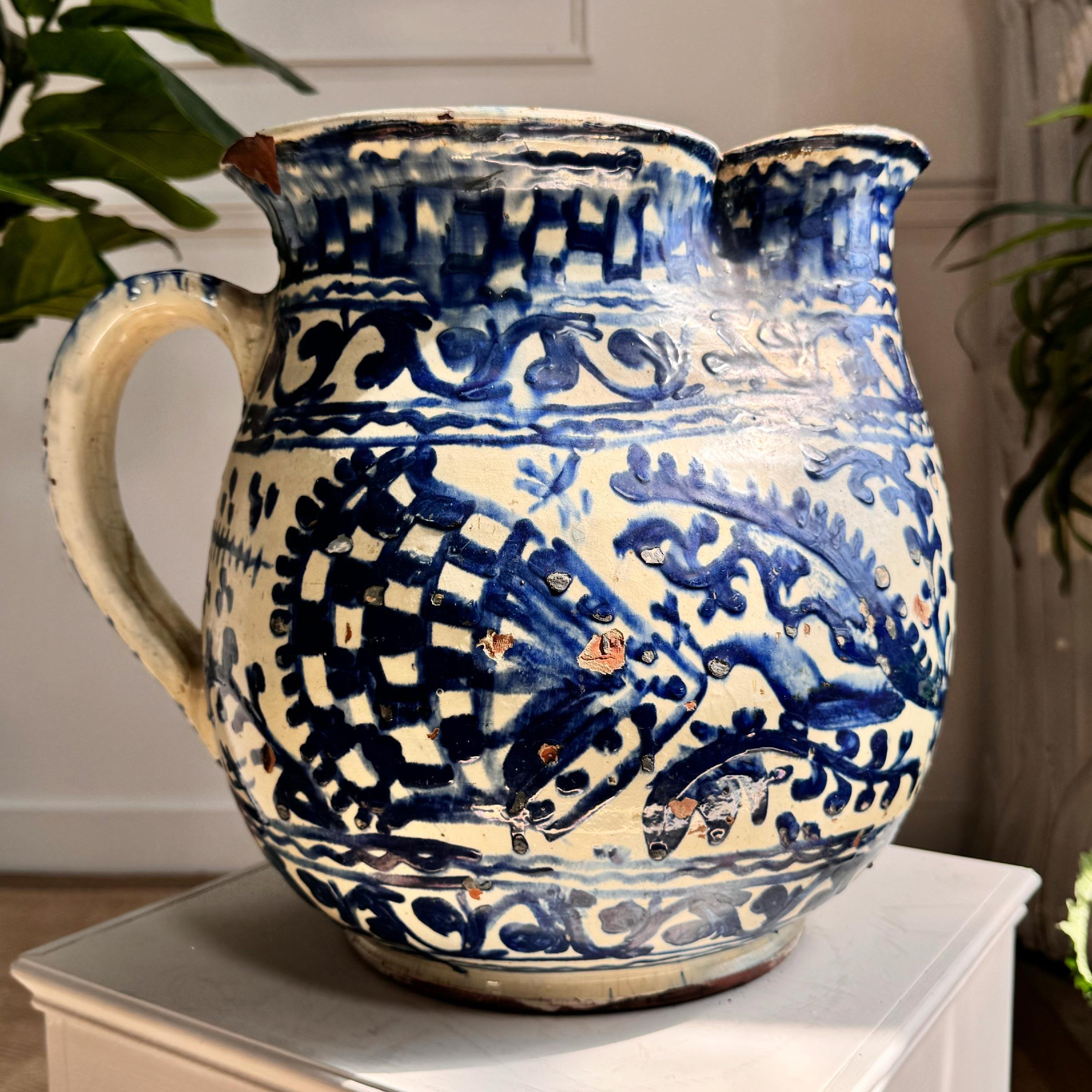 A stunning large studio pottery Jug, glazed earthenware with a slipware stylized polychrome decoration. Clearly marked to the base. The Troita studio was a prominent studio producer of handcrafted ceramics in the early 20th century, during the