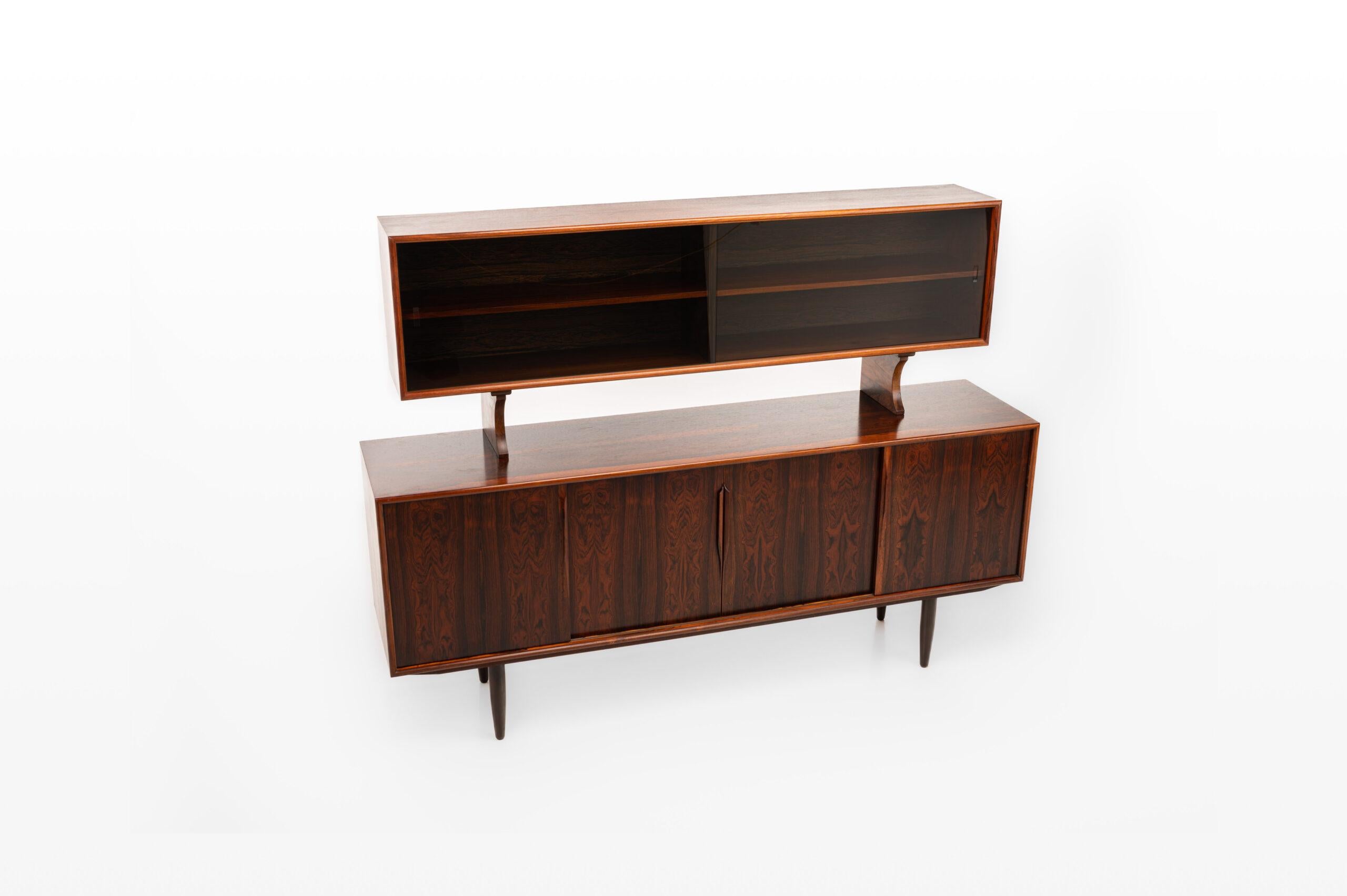Vintage buffet sideboard by Axel Christensen for ACO Møbler, Denmark 1960s. Beautifully designed sideboard in rosewood with elegant handles, three drawers and plenty of storage space with adjustable shelves. The sideboard is marked by the