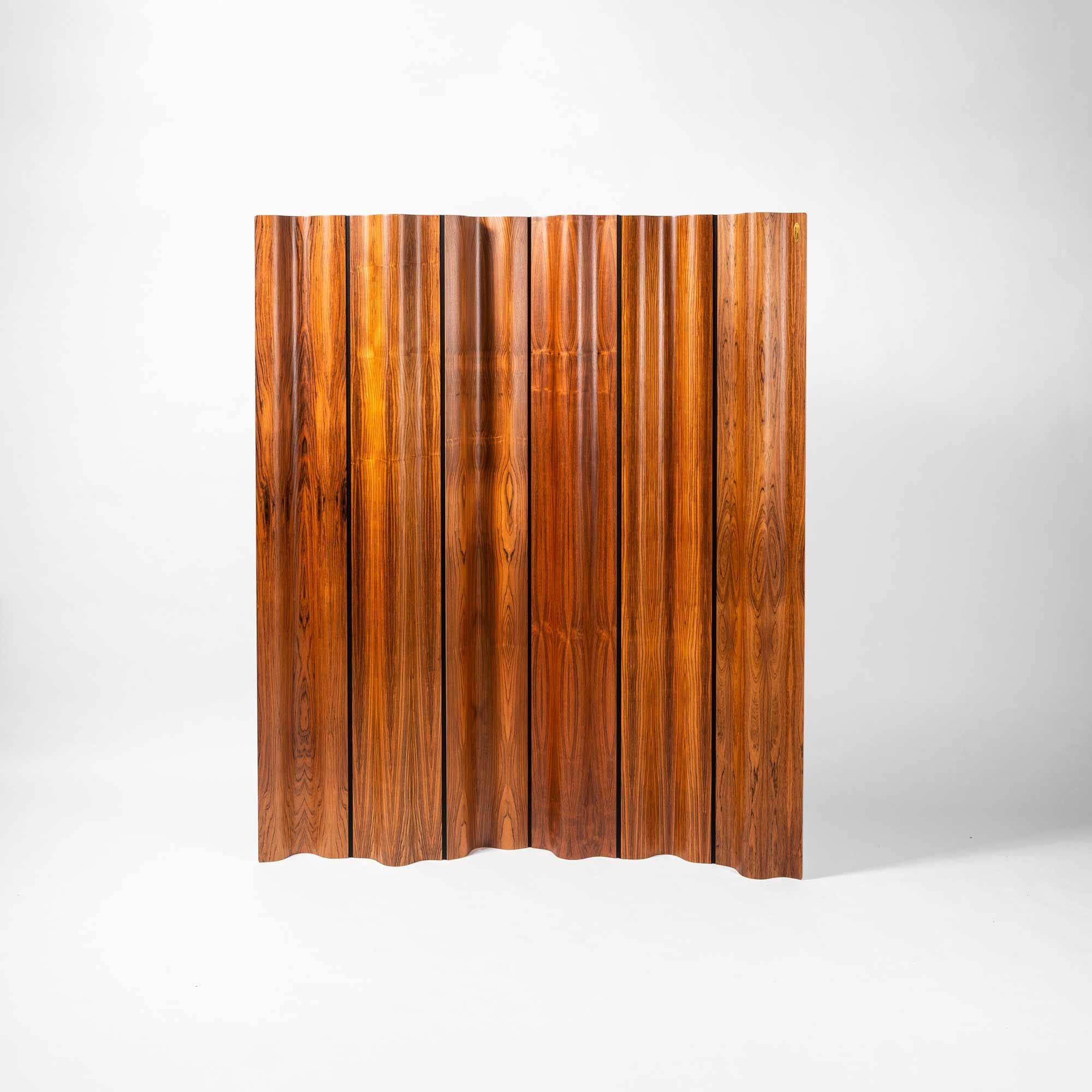 Limited edition of the Eames folding screen (FSW-6) in rosewood, numbered 155/500. The design of the screen was a clever combination of molded plywood panels and a flexible cotton canvas band in between each. The panels were shaped to the same exact