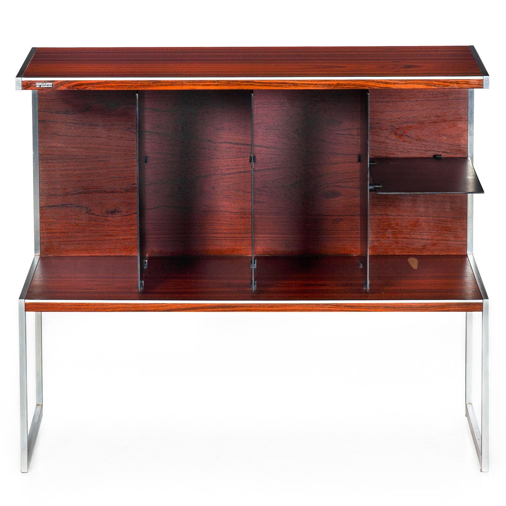 BRAZILIAN ROSEWOOD AND BRUSHED-STEEL MEDIA SHELF CONSOLE
Jacob Jensen for Bang & Olufsen  Denmark  retains original label  circa 1980s
Item # 311LEJ02P

This unique media console, both chic and practical, stands out as a rare vintage treasure.