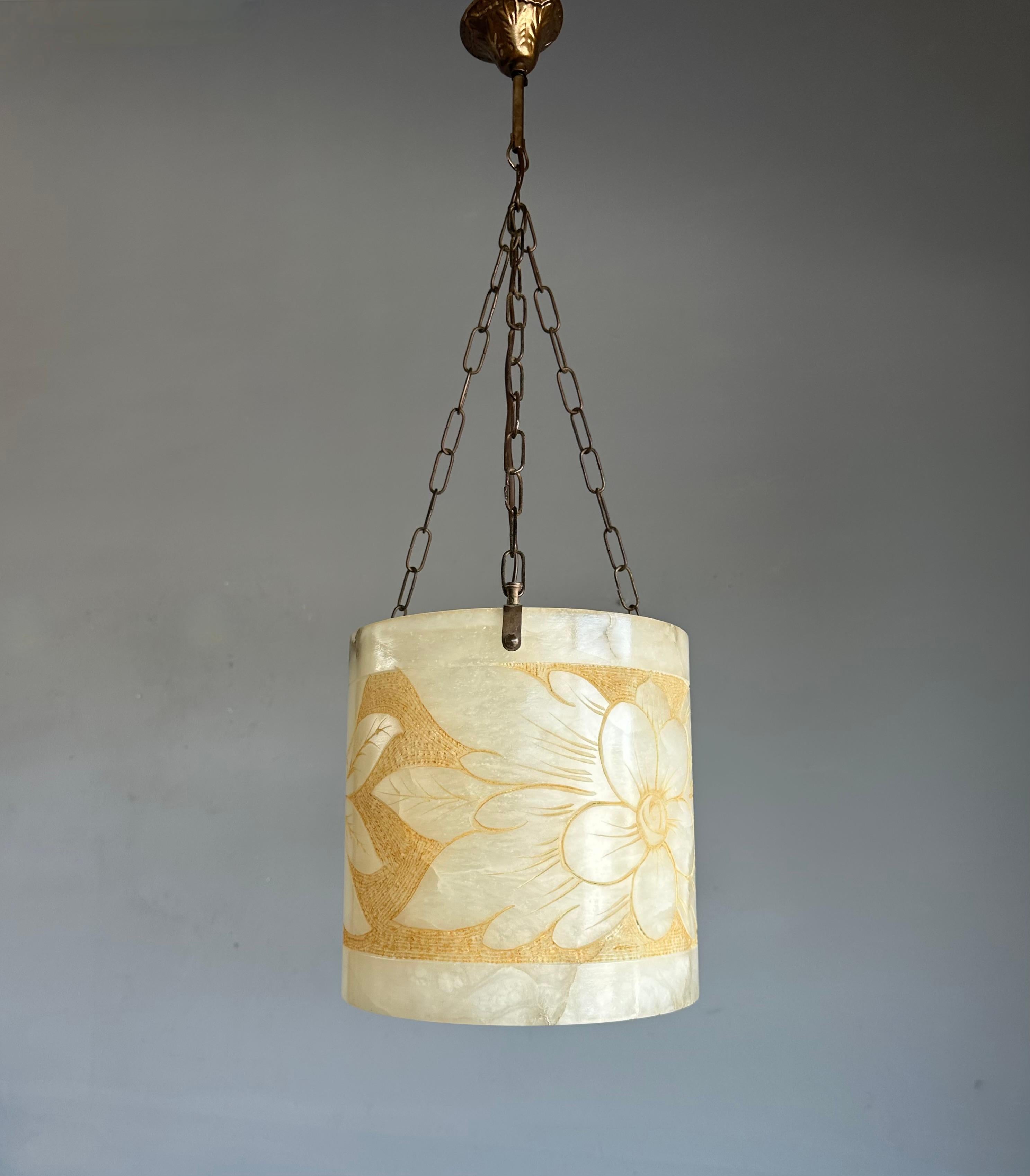 Great shape, floral design and practical size hand carved alabaster pendant / lantern with brass chain and canopy.

With twentieth century lighting as one of our specialities in general and with vintage and antique alabaster lights in particular we