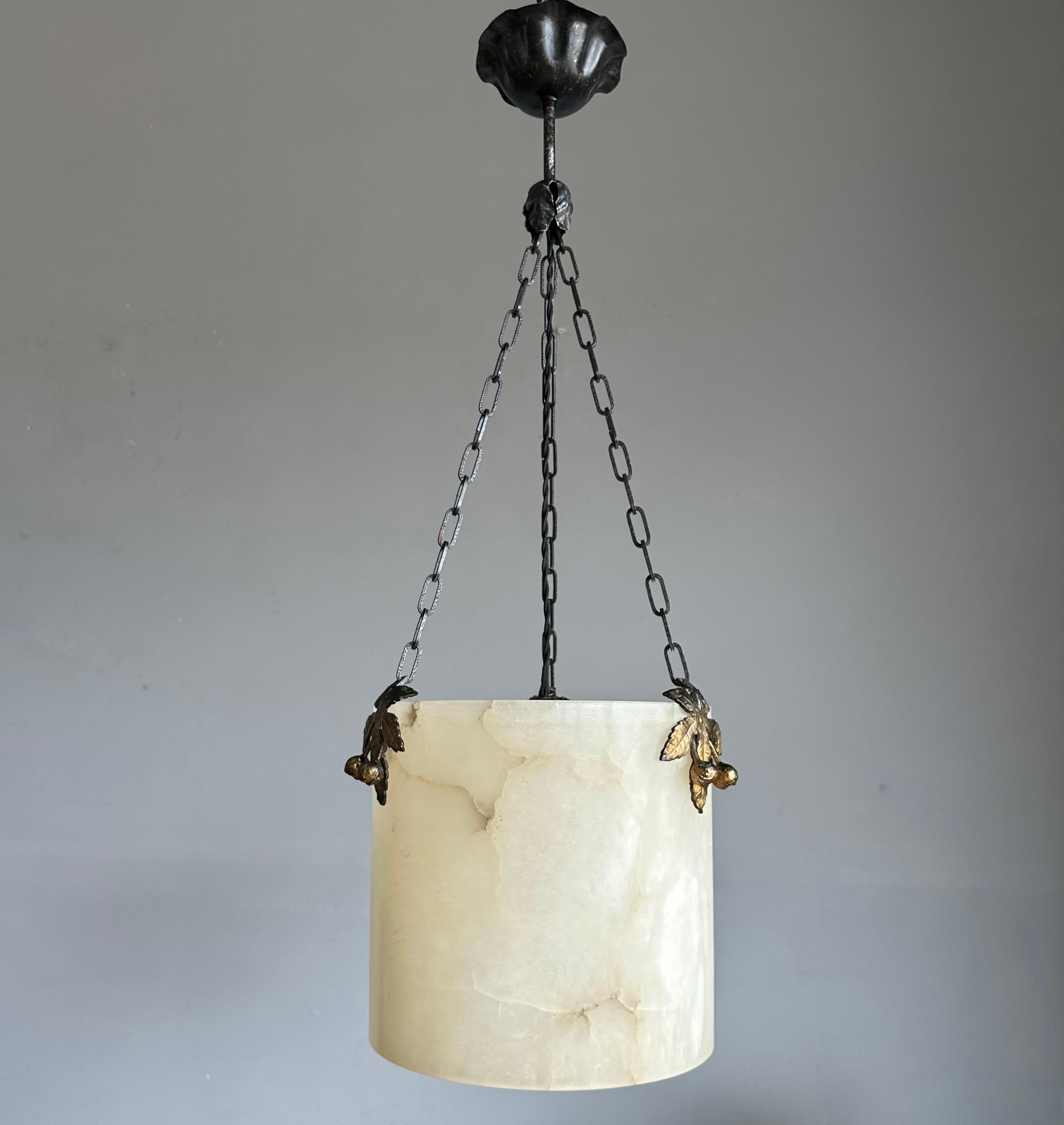 Great shape and practical size alabaster pendant with blackened metal canopy.

With twentieth century lighting as one of our specialities in general and with vintage and antique alabaster lights in particular we were again thrilled to find a design
