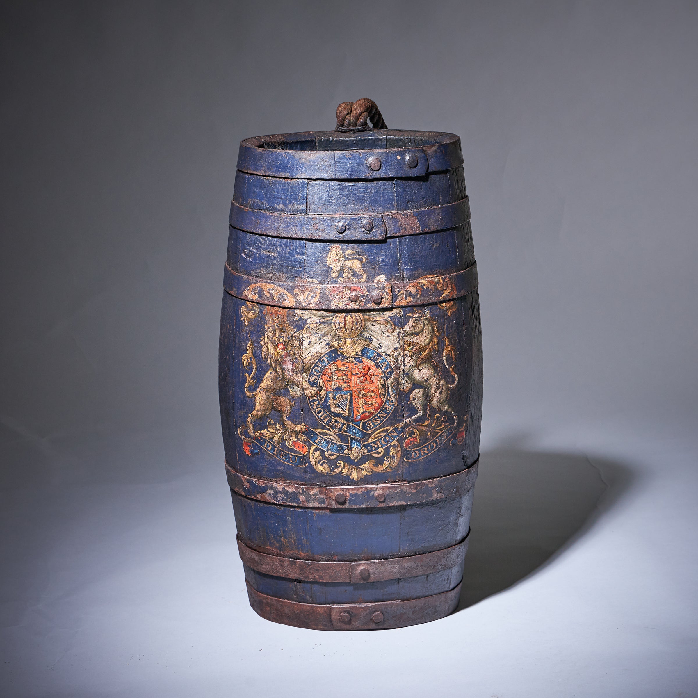 The oak barrel crafted during the 1700’s,  features a hand-painted Royal coat of arms of England on a dark Navy blue ground. Most likely used on a navel ship for gun powder or for serving grog (rum diluted with water and citrus fruits). 

The small