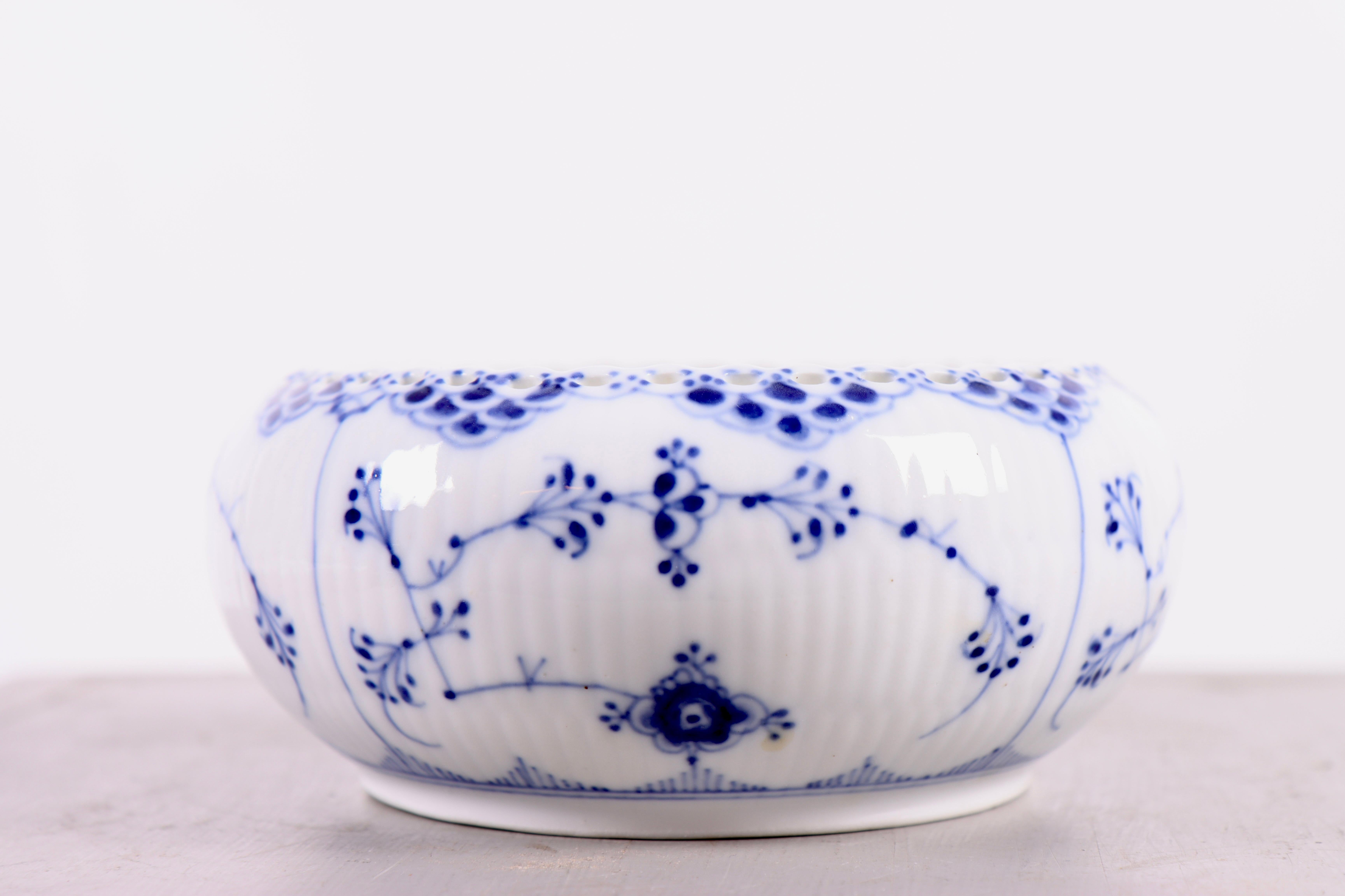 This rare Royal Copenhagen sugar bowl in the Blue Fluted Full Lace pattern is a beautiful example of classic Danish porcelain art. Produced between 1898 and 1923 in Copenhagen, the bowl exudes the timeless elegance and precision that Royal