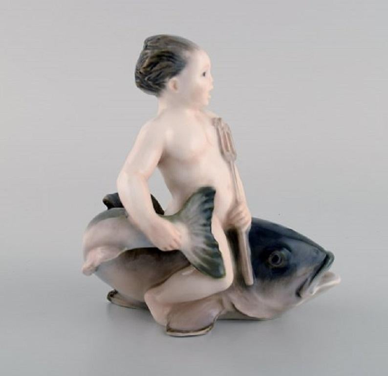 Rare Royal Copenhagen porcelain figurine. Boy sitting on a fish, 1920s. Model number 2347.
Measures: 13 x 12.5 cm.
In excellent condition.
Stamped.
1st factory quality.