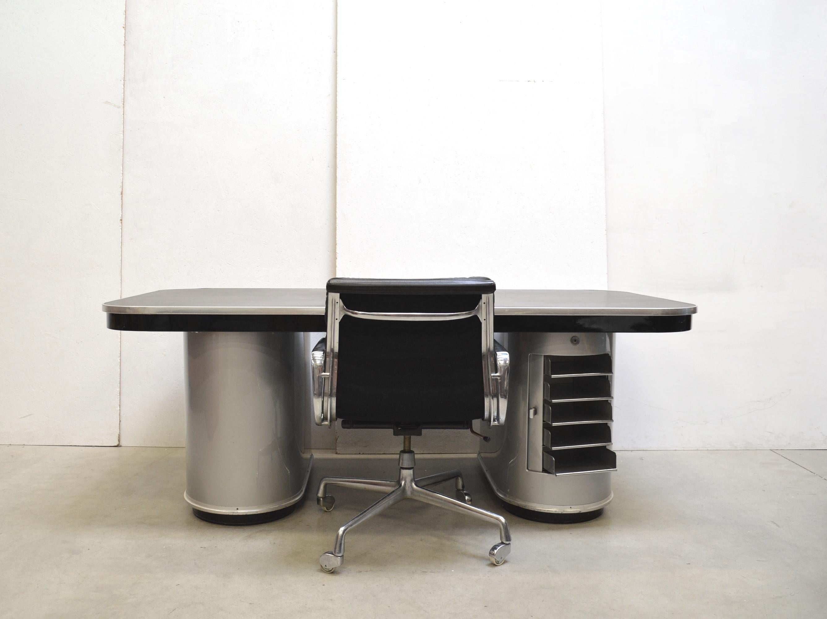 This rare and impressive Berlin executive desk from the Rundform series was designed in the 40s and produced by Mauser Werke in the late 40s. The impressive piece features 2 elements one of it with a circular drawer mechanism. 

The desk was 20