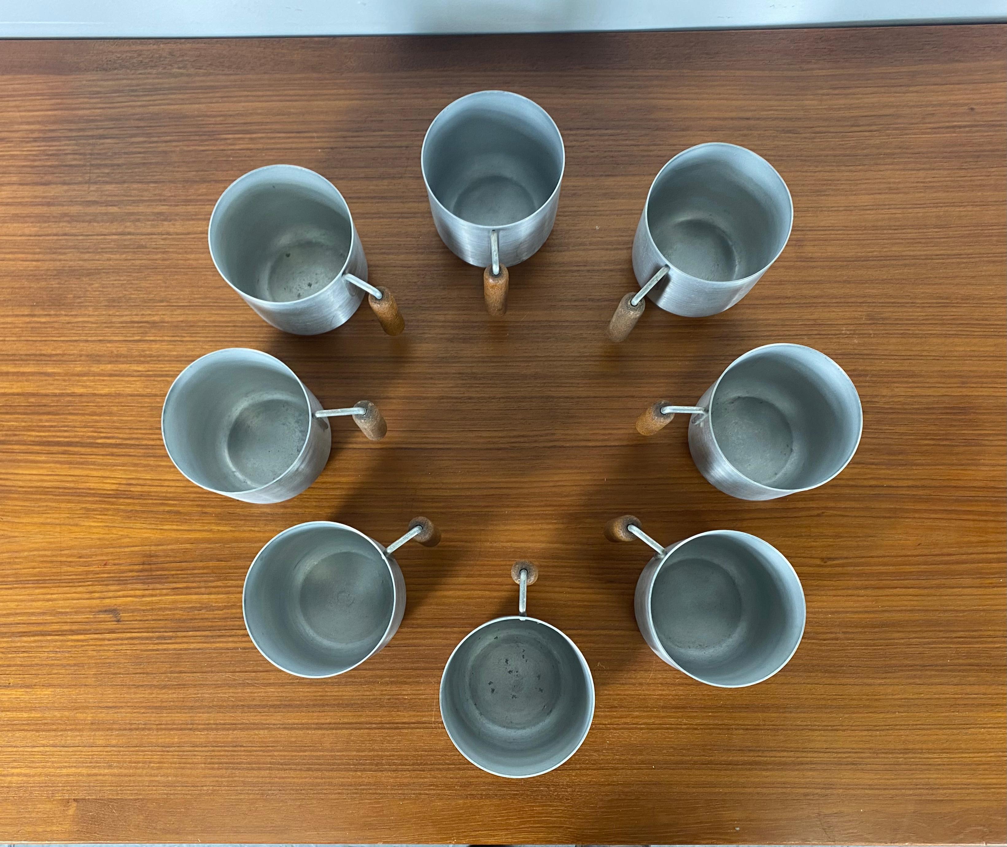 Seldom seen set of 8 Spun Aluminum and Cork Tankards / Mugs designed by Russel Wright.. Beautiful original condition, All retain Impressed Russel Wright stamp, Functional as well as wonderful Modernist sculpture.