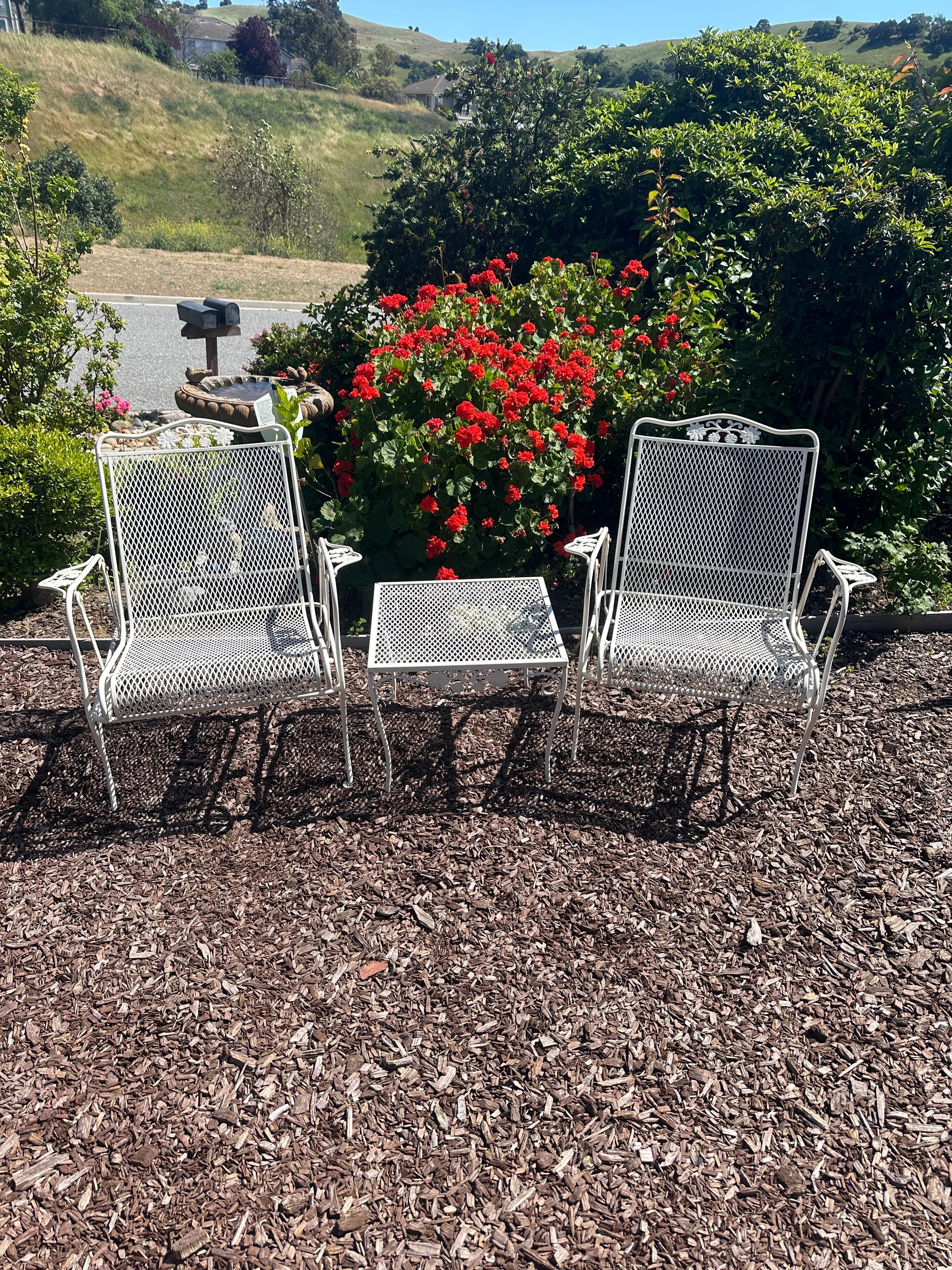 A beautiful set of gliding chairs with matching side table.
Salterini collection 
Daisies pattern
Made by Russell Woodard
Circa 1960’s
Made of wrought Iron
Gliding chairs in great working condition 
Table is 19.5” square and 16” height 
No makers