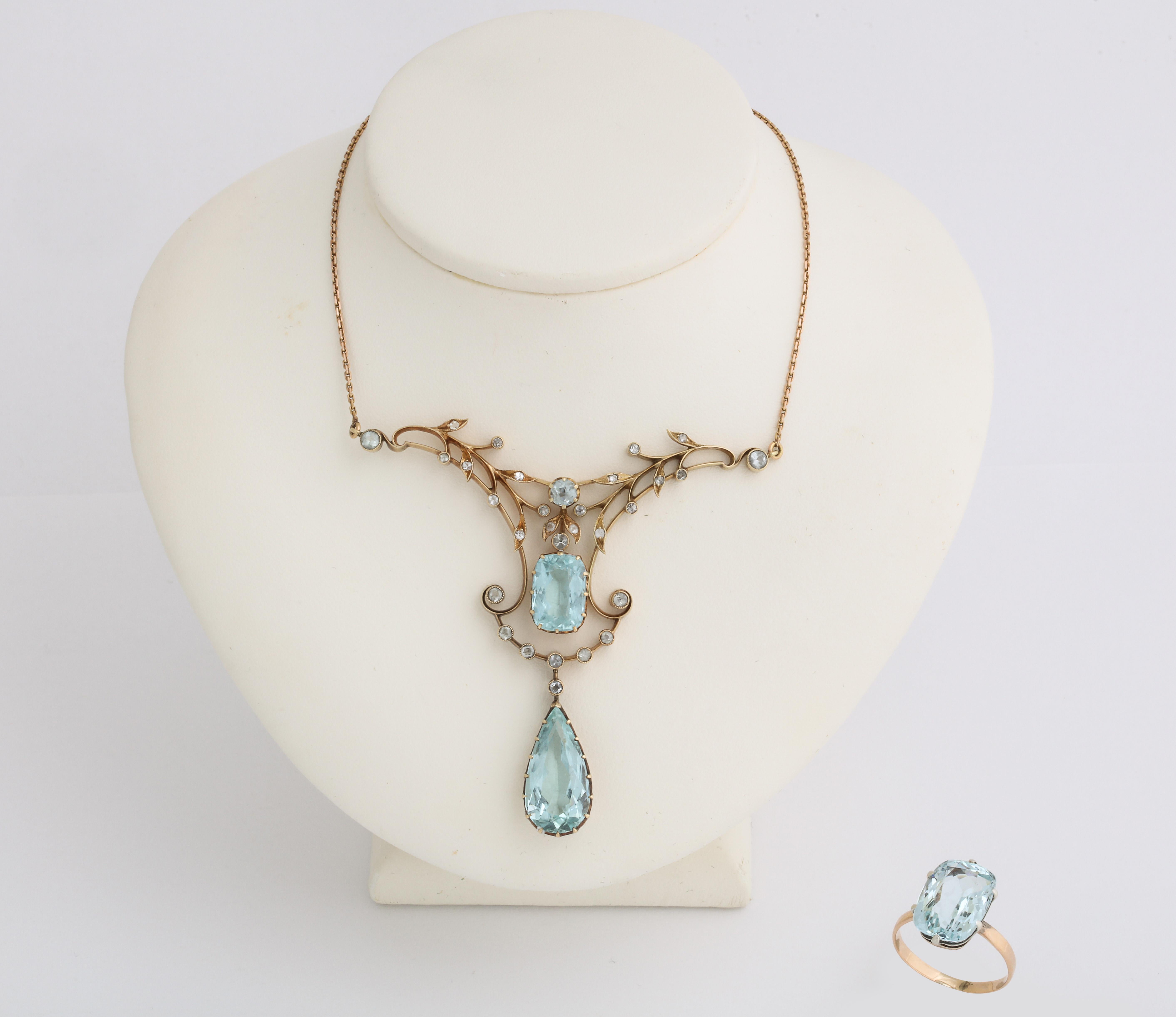 This rare Russian demi-parure is from the Romanov era, period of Tsar Nicholas II. It comprises a garland style necklace of scrolling and foliate design set with a pear-shaped aquamarine suspended from a cushion-shaped aquamarine and is accented by