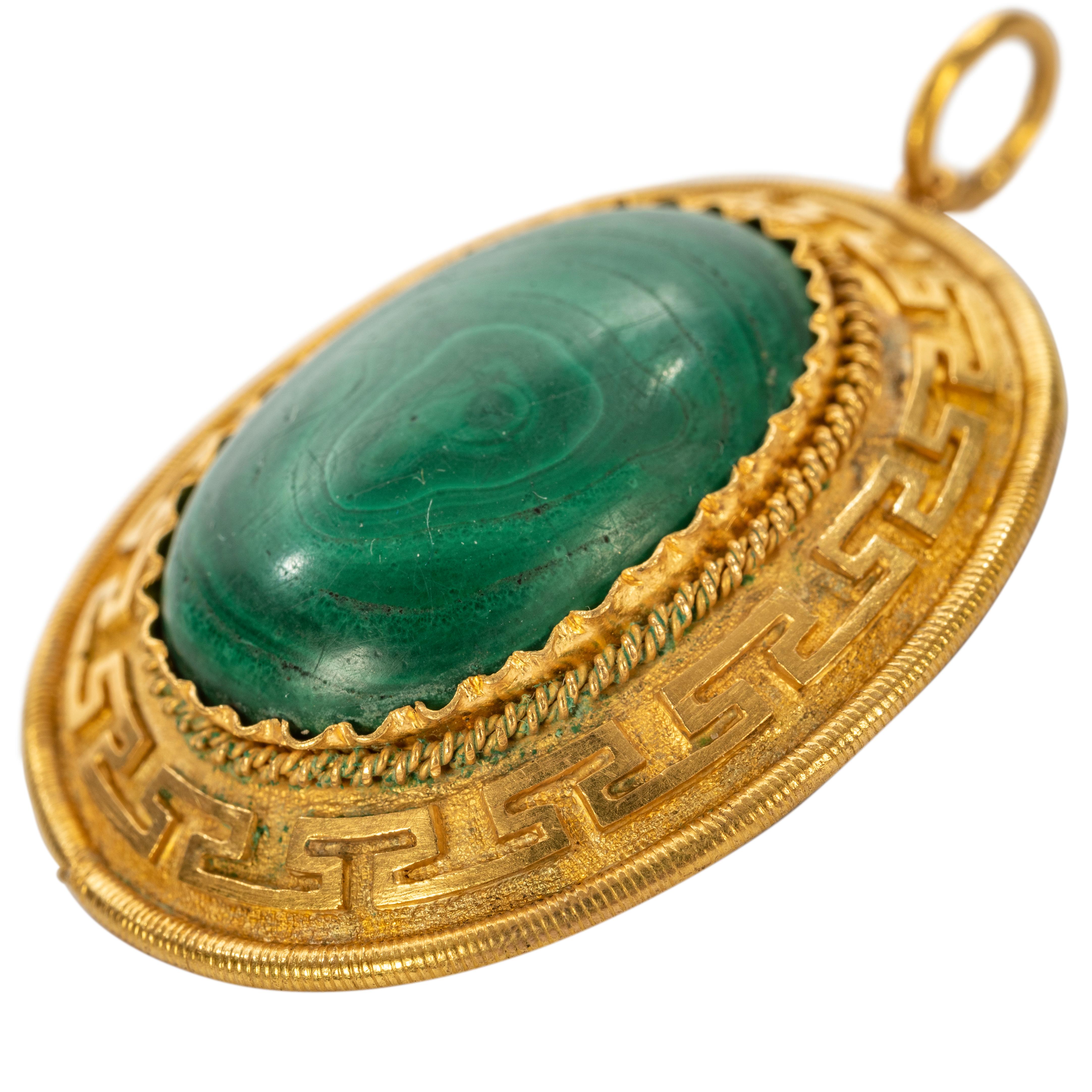 Of Neoclassical taste from the Romanov era period of Tsar Alexander II, the oval malachite pendant within a gold Greek Key border, mounted in gold with a high carat matte finish. 

St. Petersburg, circa 1860

2 in. (5.1 cm) long including suspension