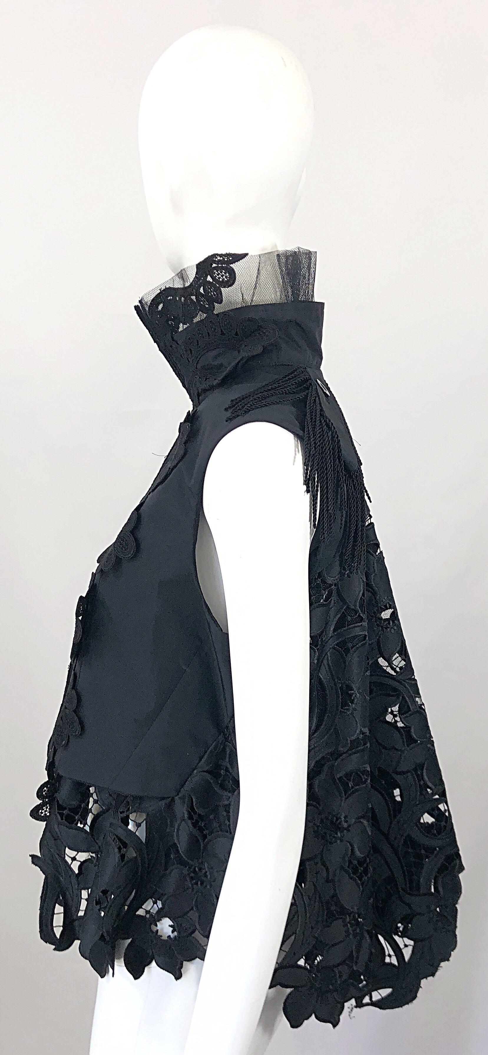 Incredible and super rare SACAI Japanese designed Avant Garde black trapeze vest top! Features intractley sewn lace and mesh throughout. Hook-and-eye closures up the front. Black corded tassel fringe at front and back of the shoulders. 
The design