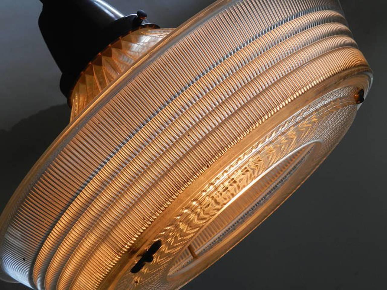 We found these dramatic looking homophone pendants packed and stored away for over 50 years. Hidden away in the attack of the original 1930s building were they where originally installed. We love Holophane lamps because of the wonderful light they