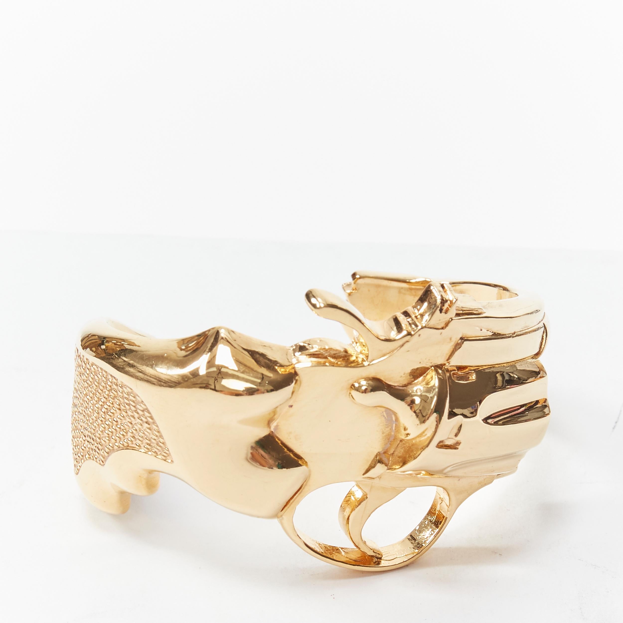 rare SAINT LAURENT 2014 Hedi Slimane Revolver Pistol Gun gold brass cuff 
Reference: TGAS/B01781 
Brand: Saint Laurent 
Designer: Hedi Slimane 
Collection: 2014 Runway 
Material: Brass 
Color: Gold 
Pattern: Solid 
Extra Detail: Very rare gold cuff