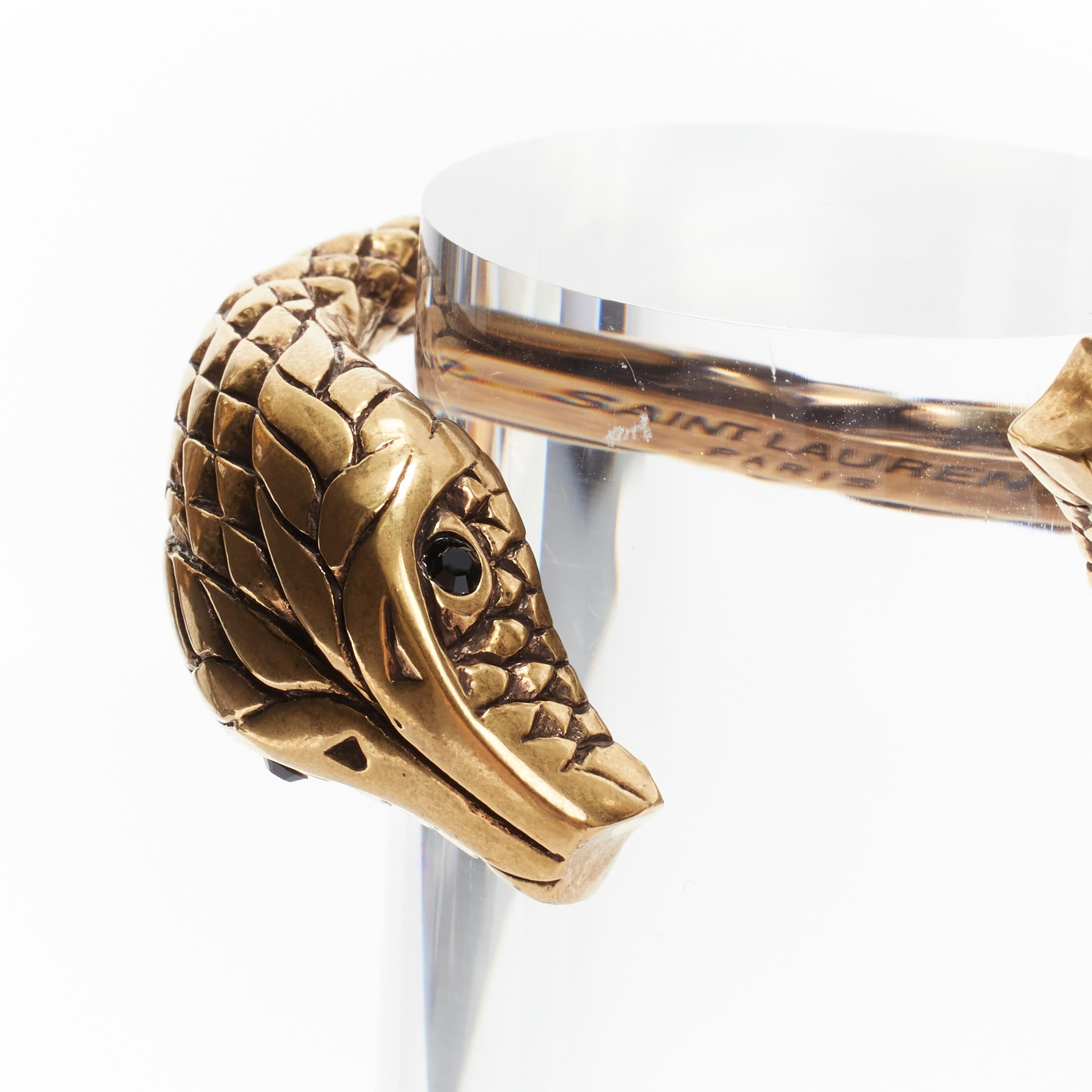 rare SAINT LAURENT Hedi Slimane dual Serpentine head crystal eye cuff bracelet 
Reference: TGAS/B01693 
Brand: Saint Laurent 
Designer: Hedi Slimane 
Material: Metal 
Color: Gold 
Pattern: Solid 
Extra Detail: Black crystal eyes. 

CONDITION:
