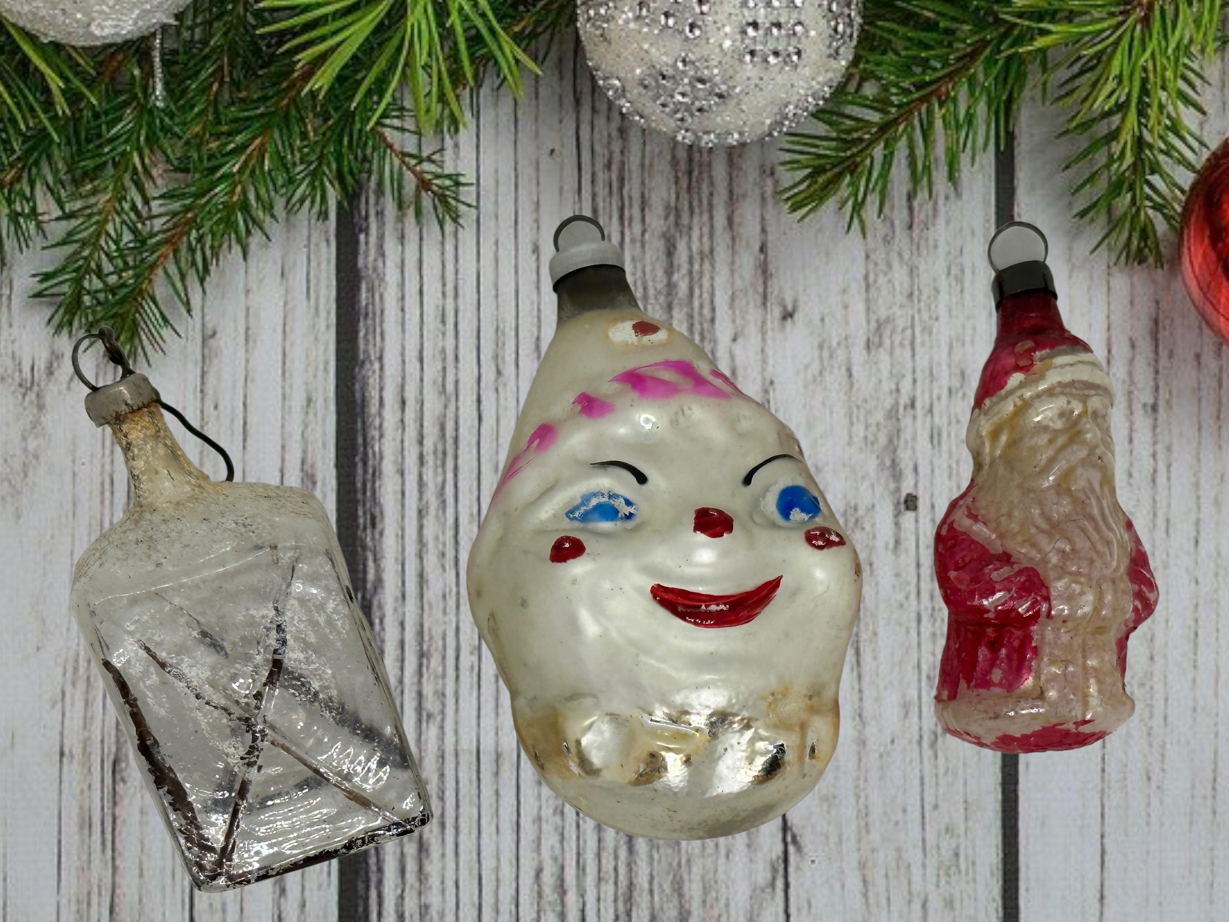 A rare Christmas ornament set of three. Each is made from mouth blown glass, this would be a great addition for your Christmas or feather tree. Clown Head is approx. 3 1/4