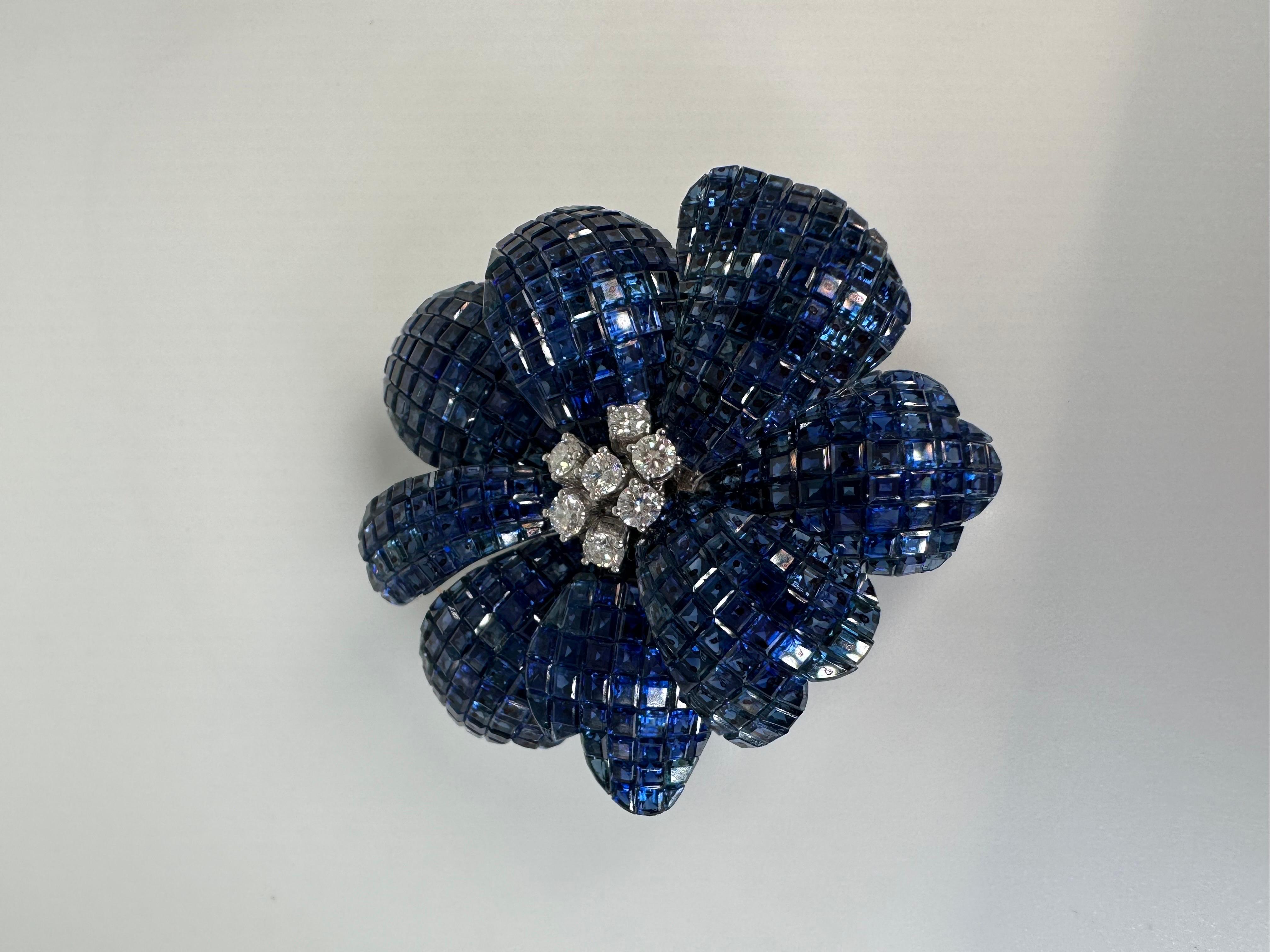 Important and rare invisbly set sapphire and diamond brooch in 18KT white gold.

GOLD: 18KT gold
NATURAL DIAMOND(S)
Clarity/Color: SI/H
Carat:0.63ct
Cut:Round
NATURAL SAPPHIRE(S)
Clarity/Color: Slightly Included/Blue
Count: 503