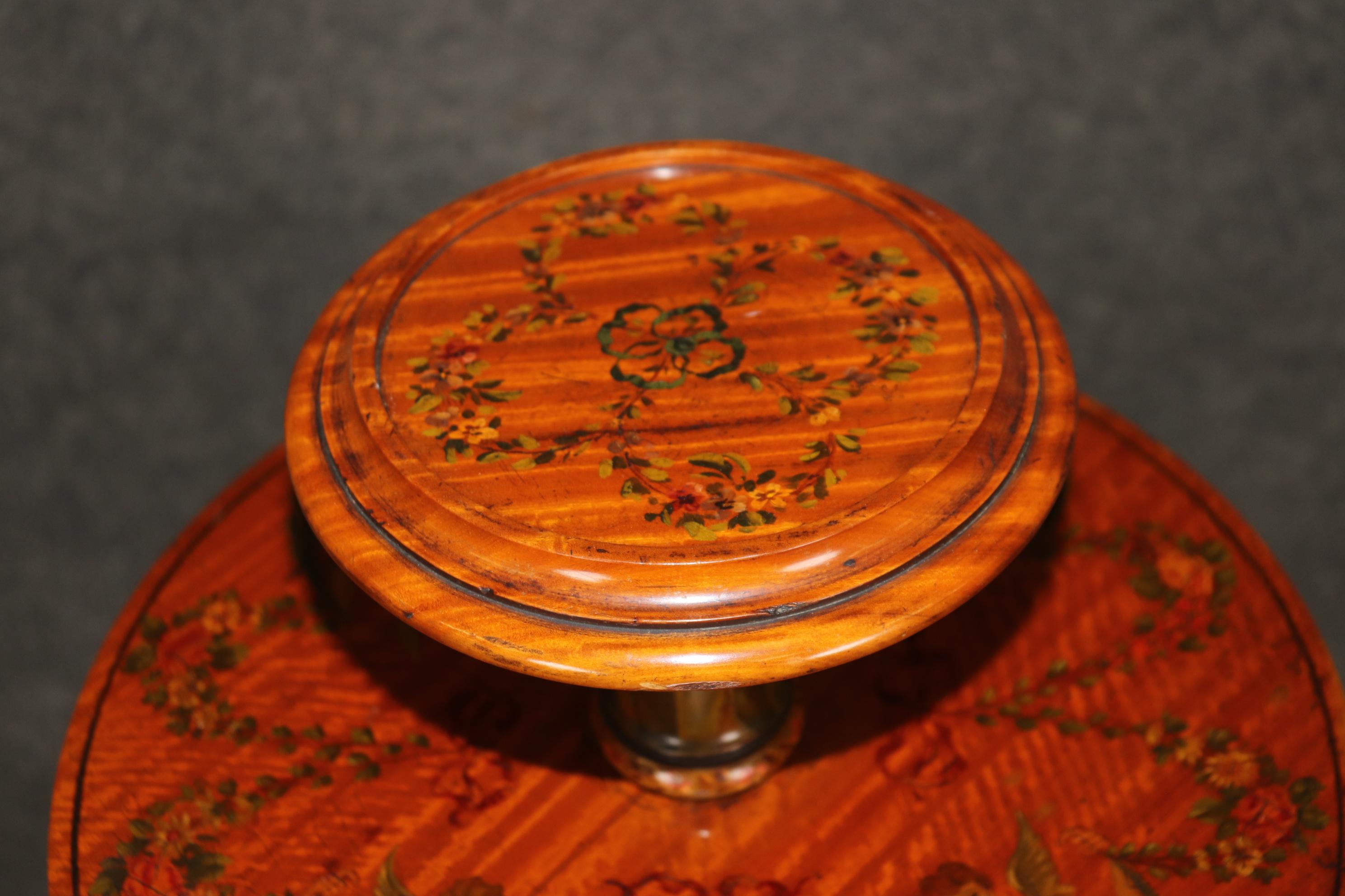 This is a superb, and very rare and fine quality revolving bookcase. The satinwood has been expertly hand-painted with swags of garlands and figural scenery in a masterful way. The piece is absolutely beautiful and such a rare gem to find in nature.