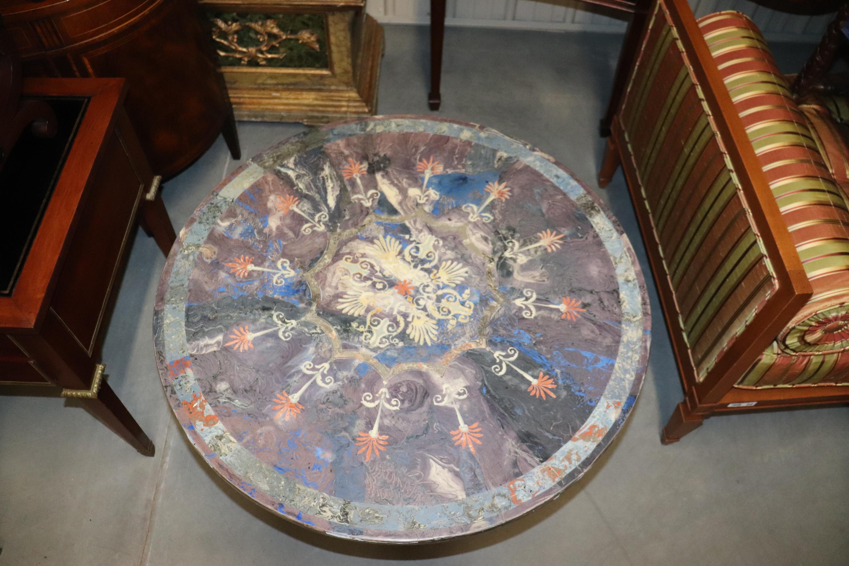 This is a fantasic Italian made scagliola center table with a separate gilded iron Hollywood Regency base. The top comes off and the top looks like its marble but in fact is made by the fine art of Italian Scagliola faux marble and is absolutely