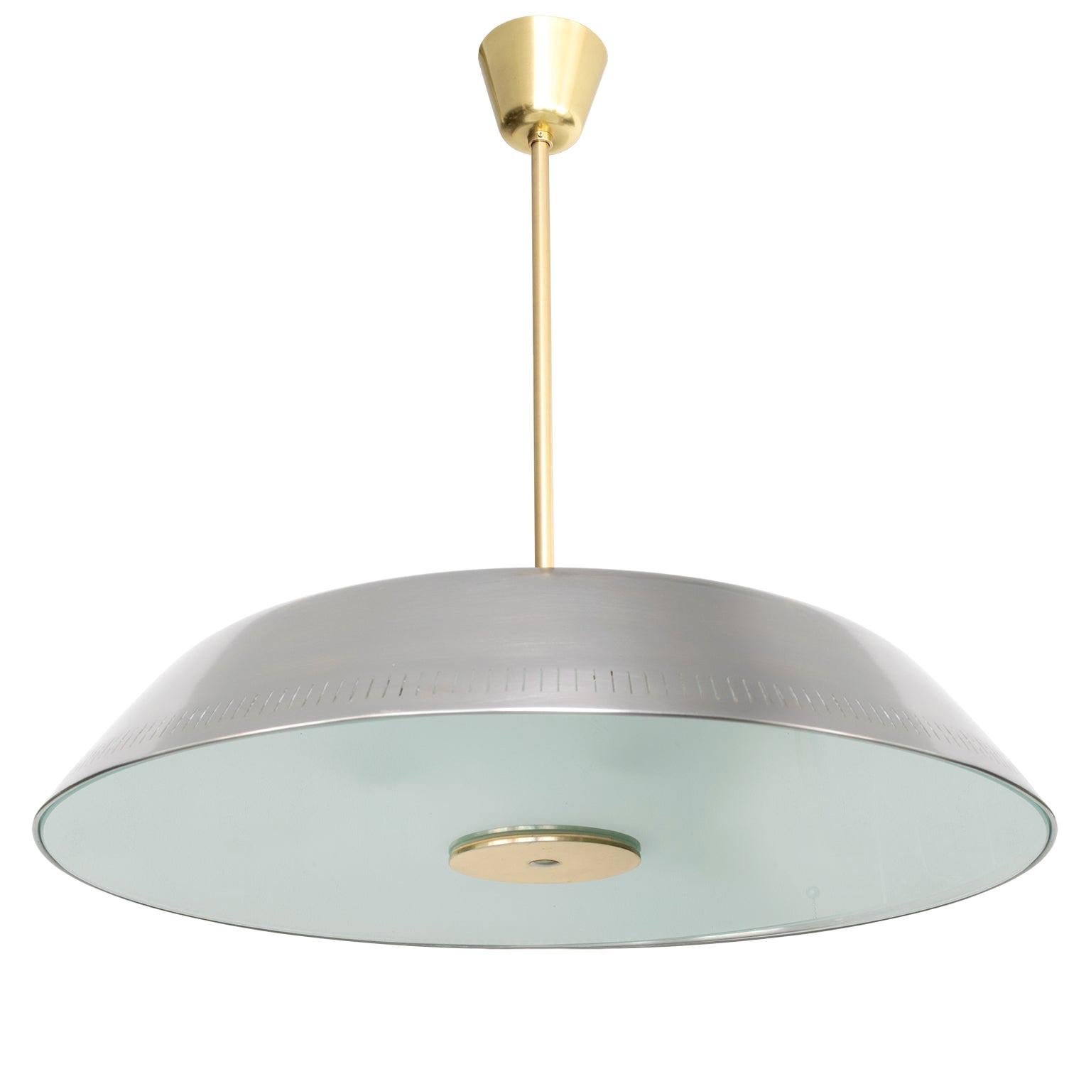 A very rare Scandinavian Modern polished steel and glass pendant designed by Harald Notini made by Böhlmarks, Sweden. This fixture has been completely restored and newly rewired with 6 internal standard base sockets and 3 additional sockets recessed