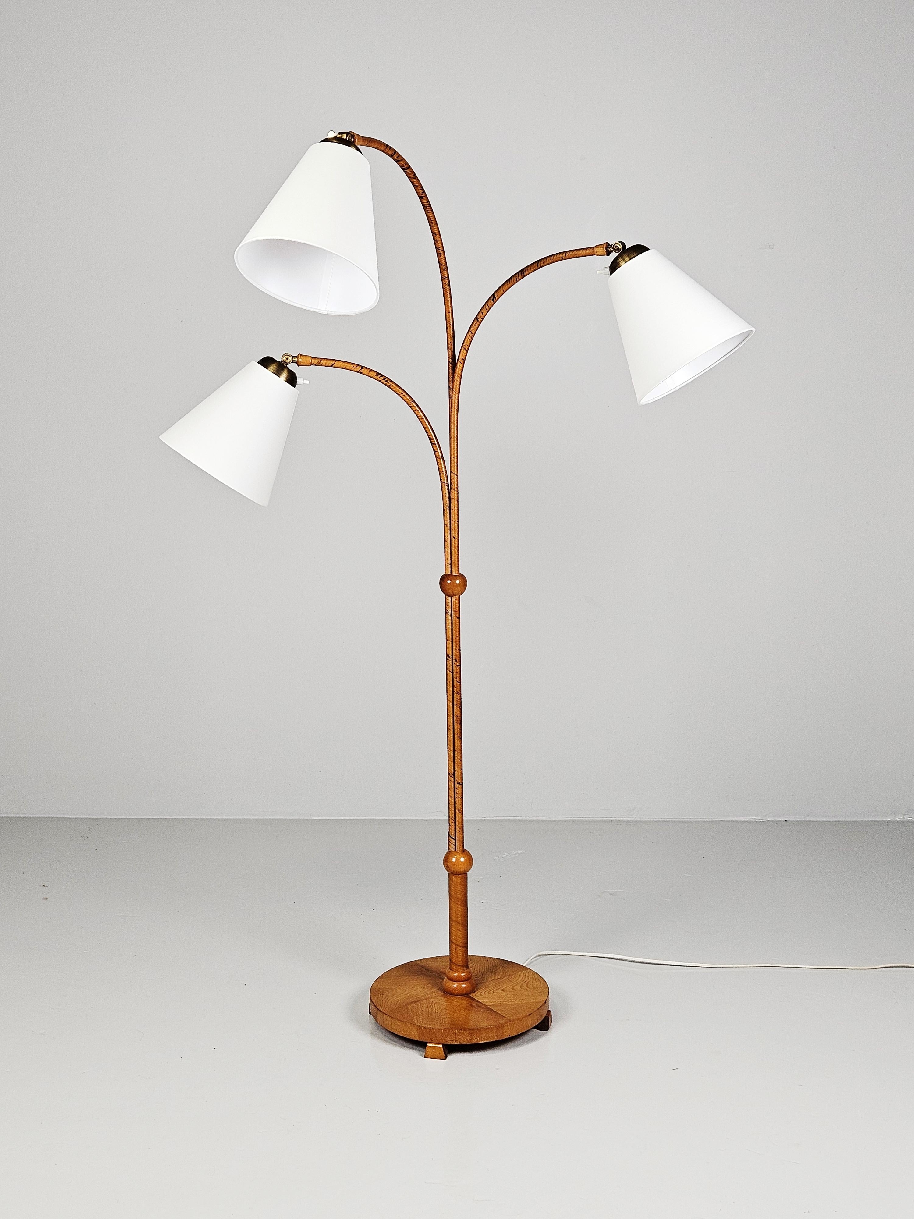Rare Scandinavian modern floor lamp by anonymous designer. Made in Sweden during the 1940s.

Arms and neck wrapped in rattan with foot with veneer. Brass details.

Adjustable arms.