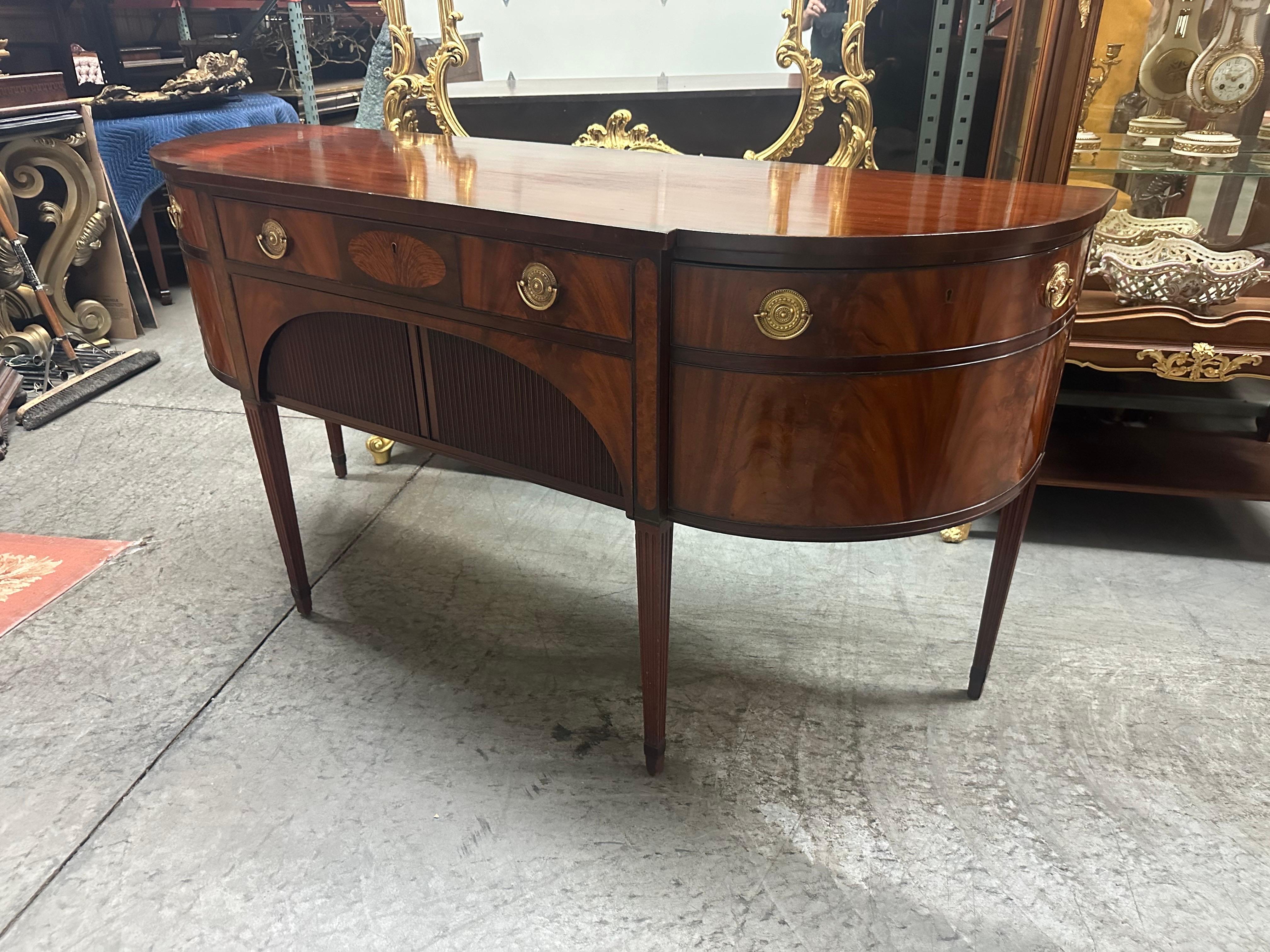 This is a completely original 1920s era Schmieg and Kotzian sideboard. The sideboard features outstanding flame mahogany and a hand-polished original finish retaining all of its original character and signs of age and minor wear. This is not a