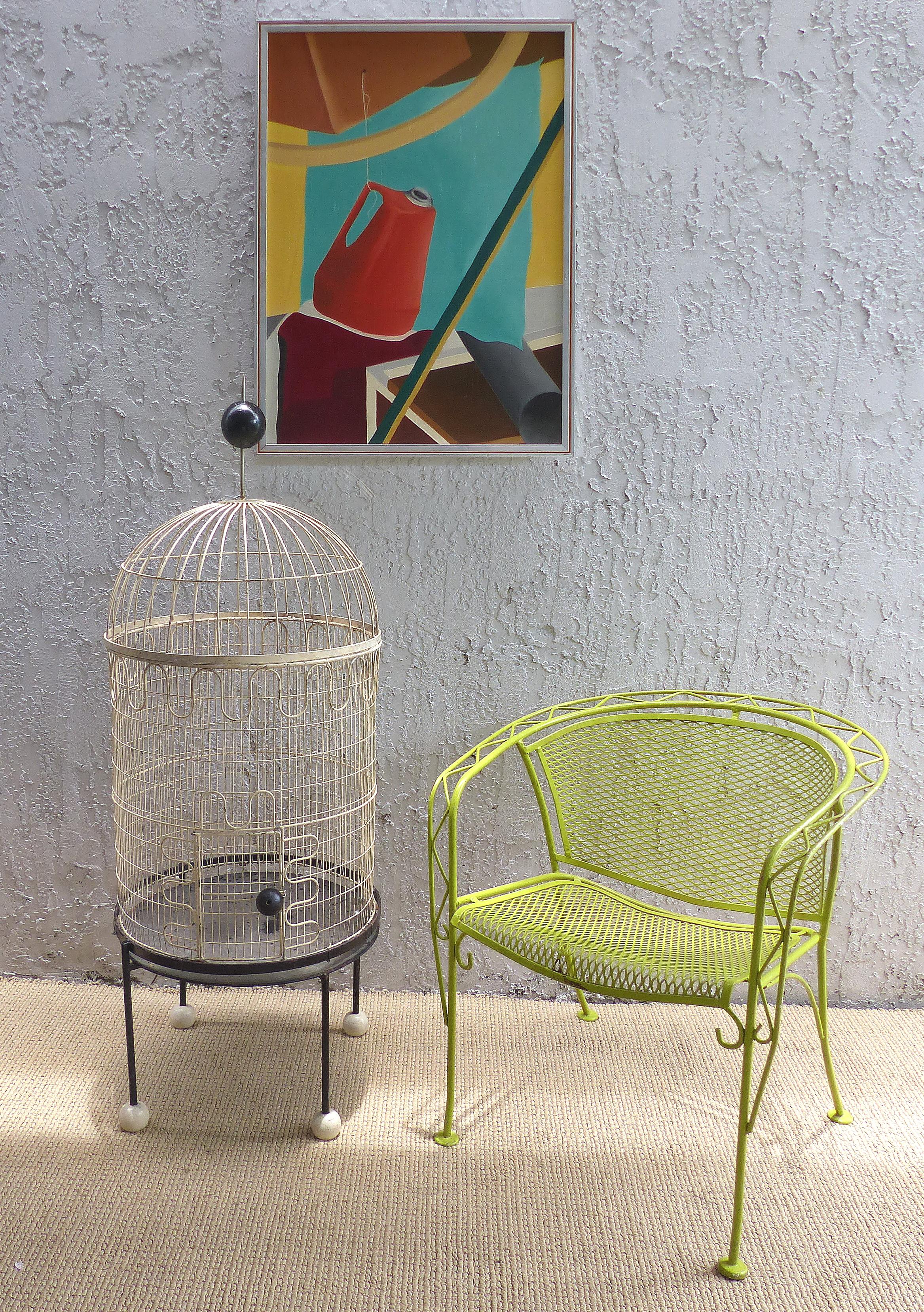 Offered for sale is a sculptural circa 1955 Mid-Century Modern decorative birdcage by Frederick Weinberg. The cage was created in wrought iron and wood with whimsical lines representative of the era. The iron repetitive curves used by Weinberg are