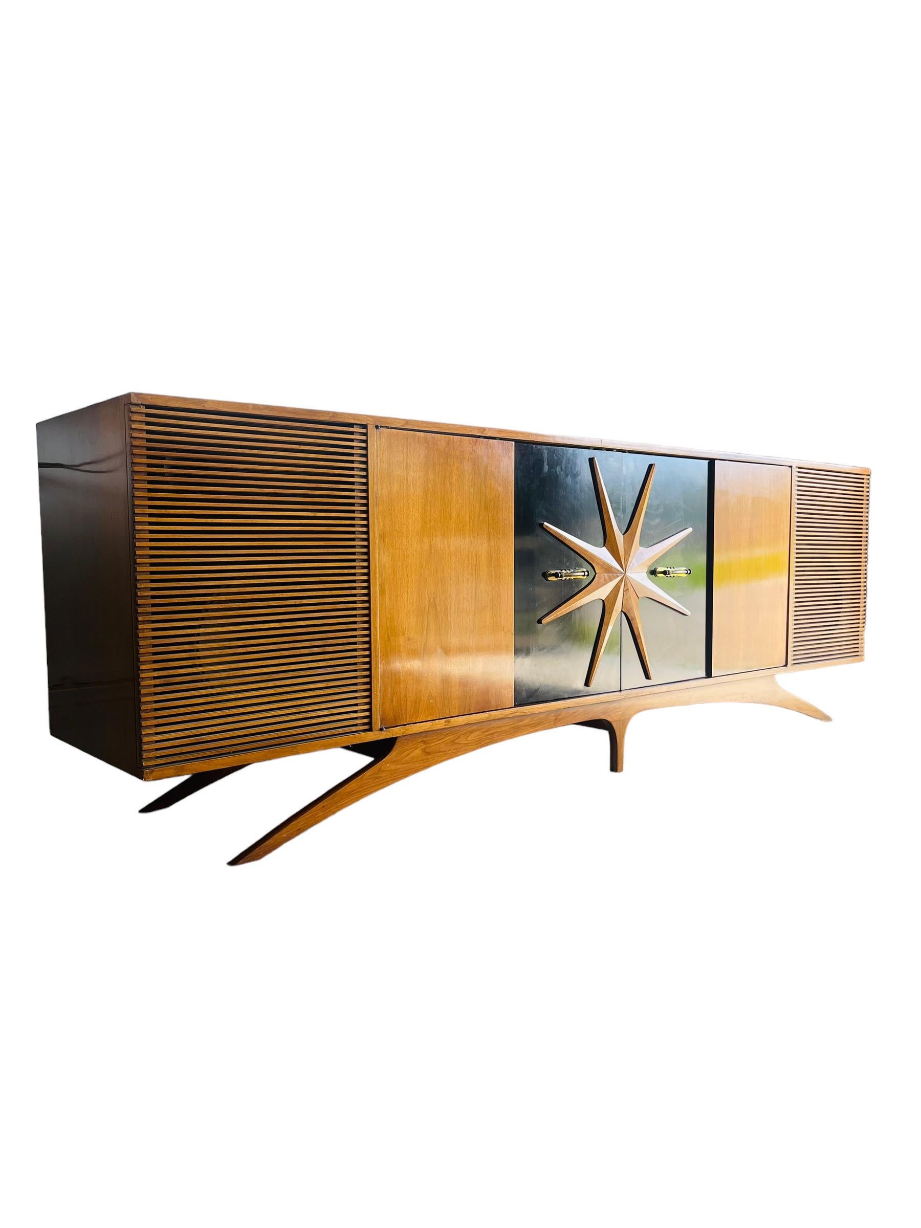 This extraordinary Mid Century Modern sculptural credenza captures both functionality and visual appeal. Reminiscent of the work of renowned designer Vladimir Kagan, this walnut cabinet showcases exceptional craftsmanship and beautiful woodgrain