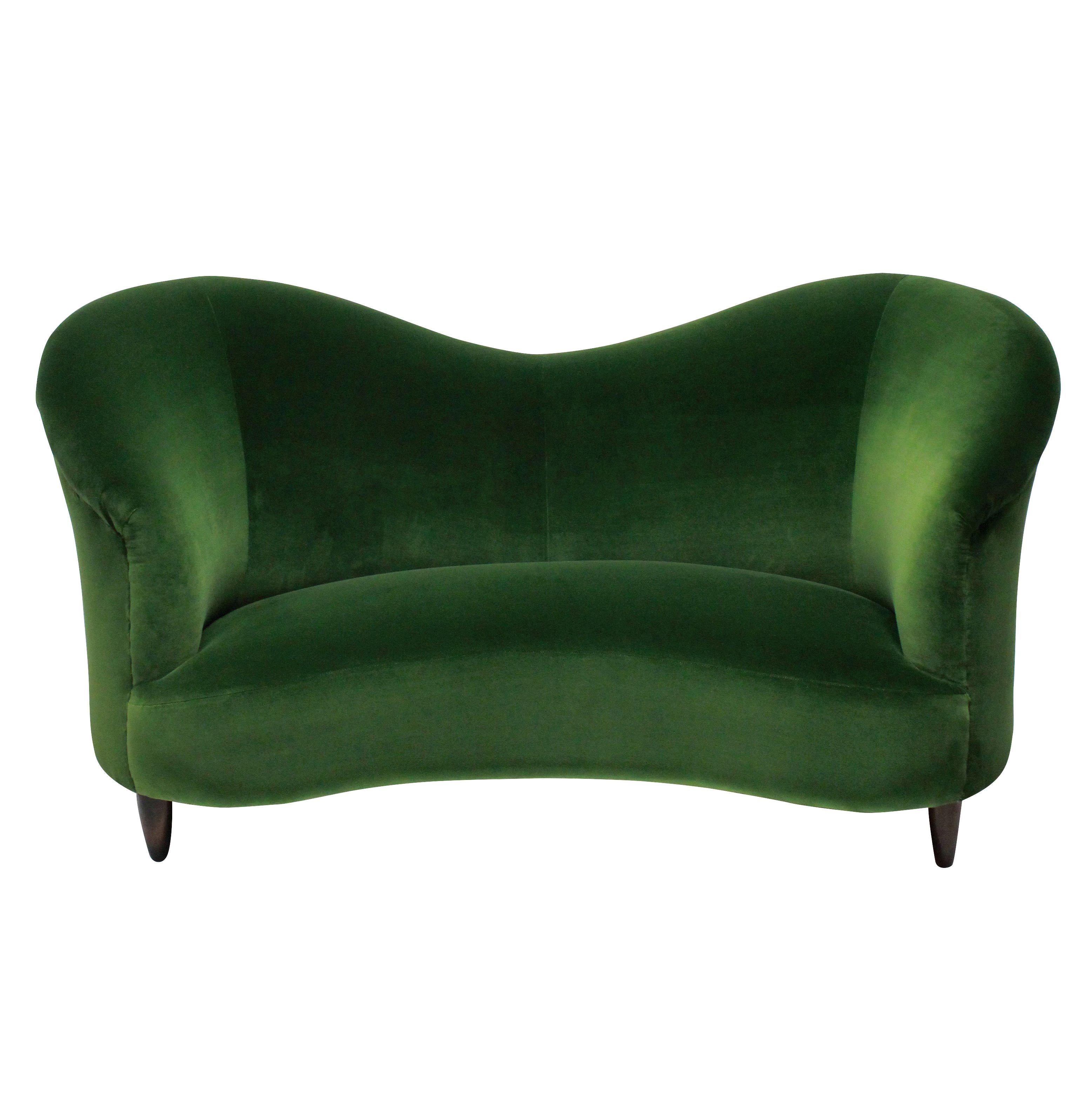 A fine Italian sculptural sofa attributed to Ico Parisi. Newly upholstered in emerald velvet.

 