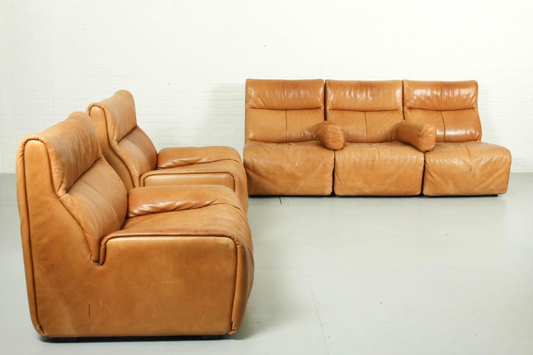 Rare Sectional Modular Sofa and Lounge Chairs manufactured by COR Germany, 1970s. Cognac leather sofa consisting of 3 elements and 2 loose armrests. All pieces are upholstered in original cognac leather. The feet of this sofa are marked.