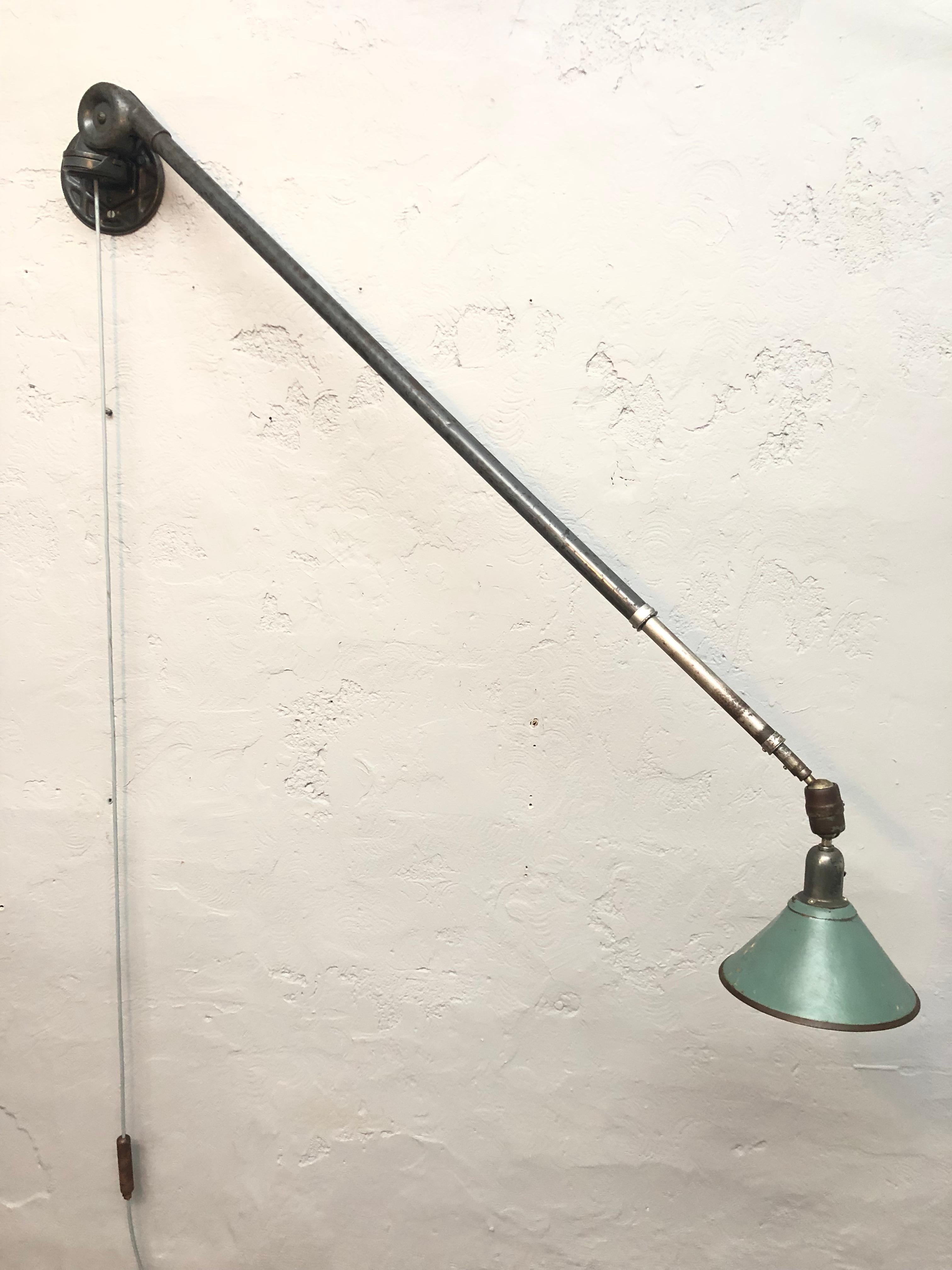 Antique series 1 Triplex telescopic work light in original condition and with the original cardboard shade. 
Has a great reach and can be extended up to 2.8 meters.
Brass counter weight for the cable.
Great patina to the surfaces.
Maybe the coolest