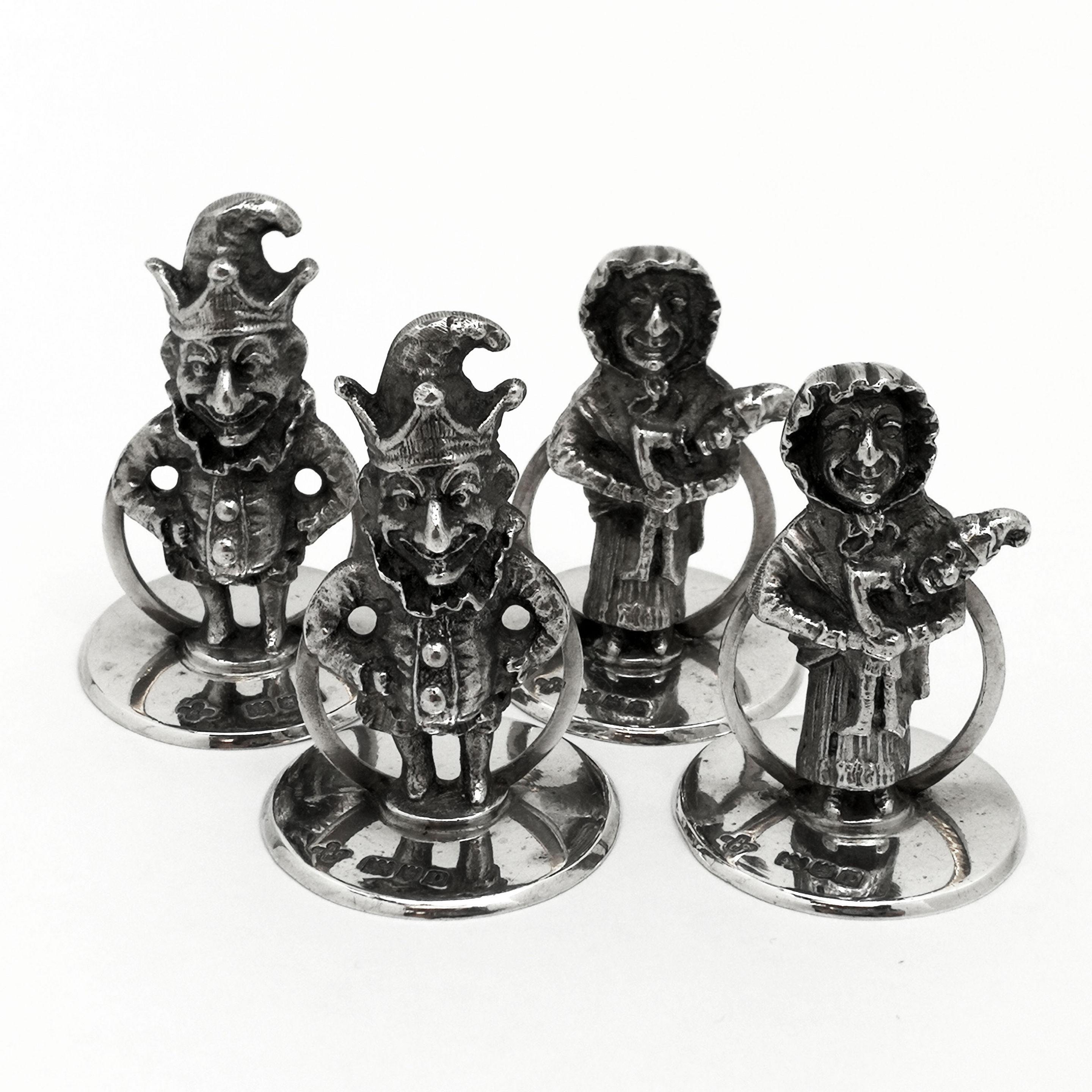A wonderful set of 4 Solid Silver Menu Holders / Place Card Holders in the shape of the iconic Punch & Judy. The Set has two of each character. Each stands on a round silver base. The figures are cast with a wonderful attention to detail and are