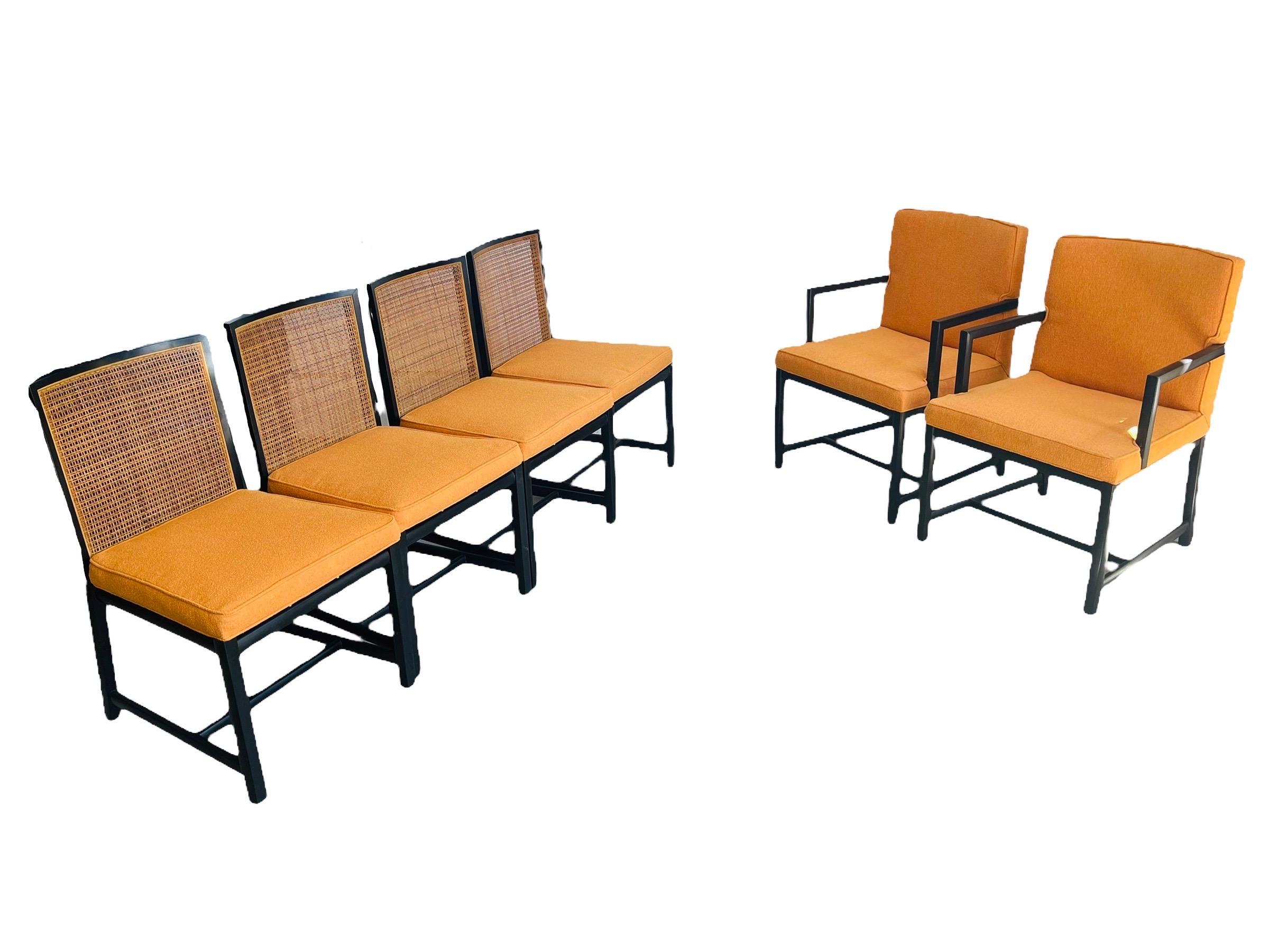 Stunning rare set of 6 cane back with black lacquer frame dining chairs designed by Michael Taylor for Baker Furniture Circa 1960. This set includes two captain chairs and 4 side chairs. This set is in good vintage condition with normal wear