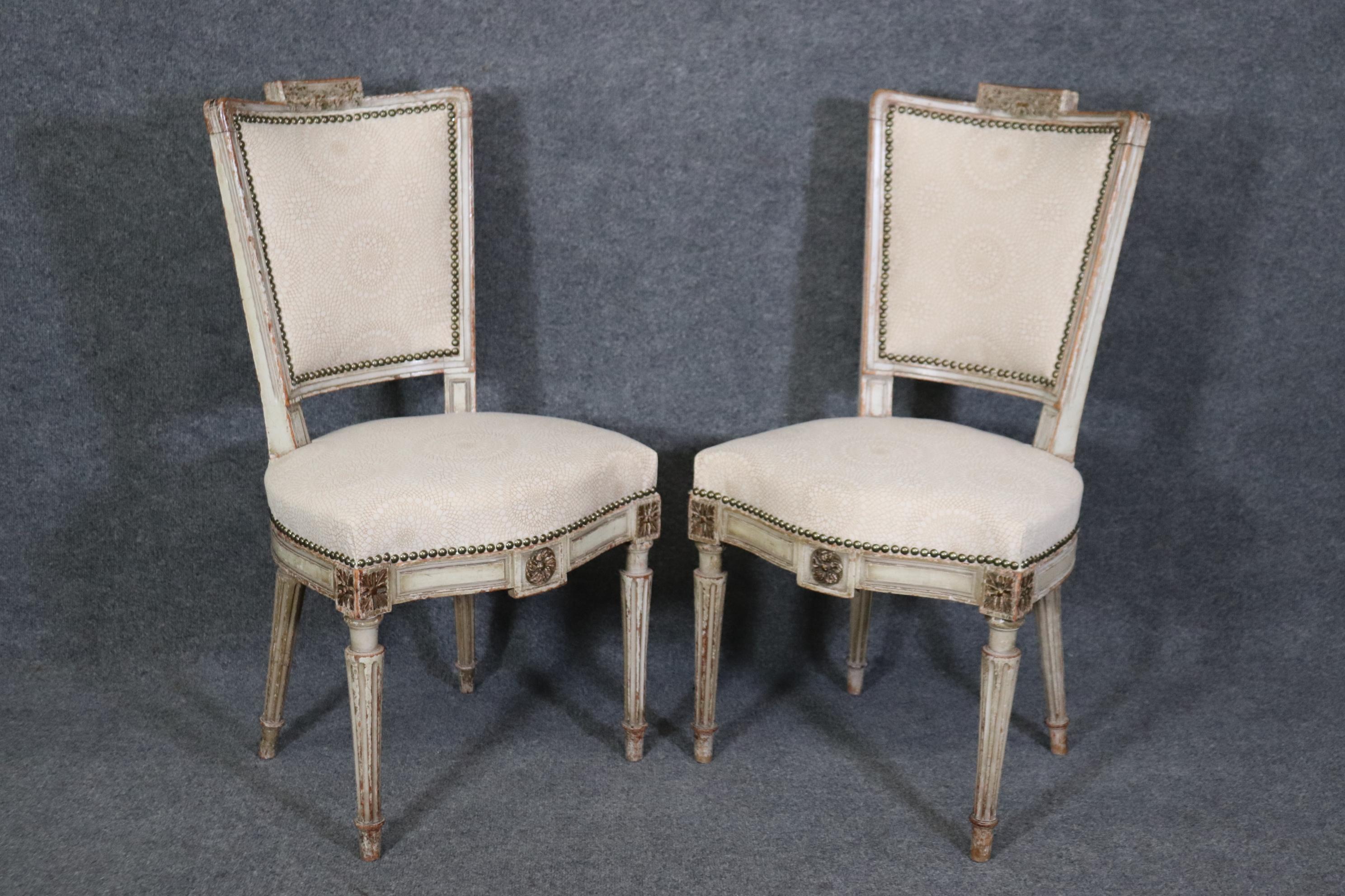 This is a spectacular and rare set of 12 signed Maison Jansen dining chairs in their original finish including the age related distressing that only time cane provide. The chairs are completely reupholstered and in new upholstery. The frames are