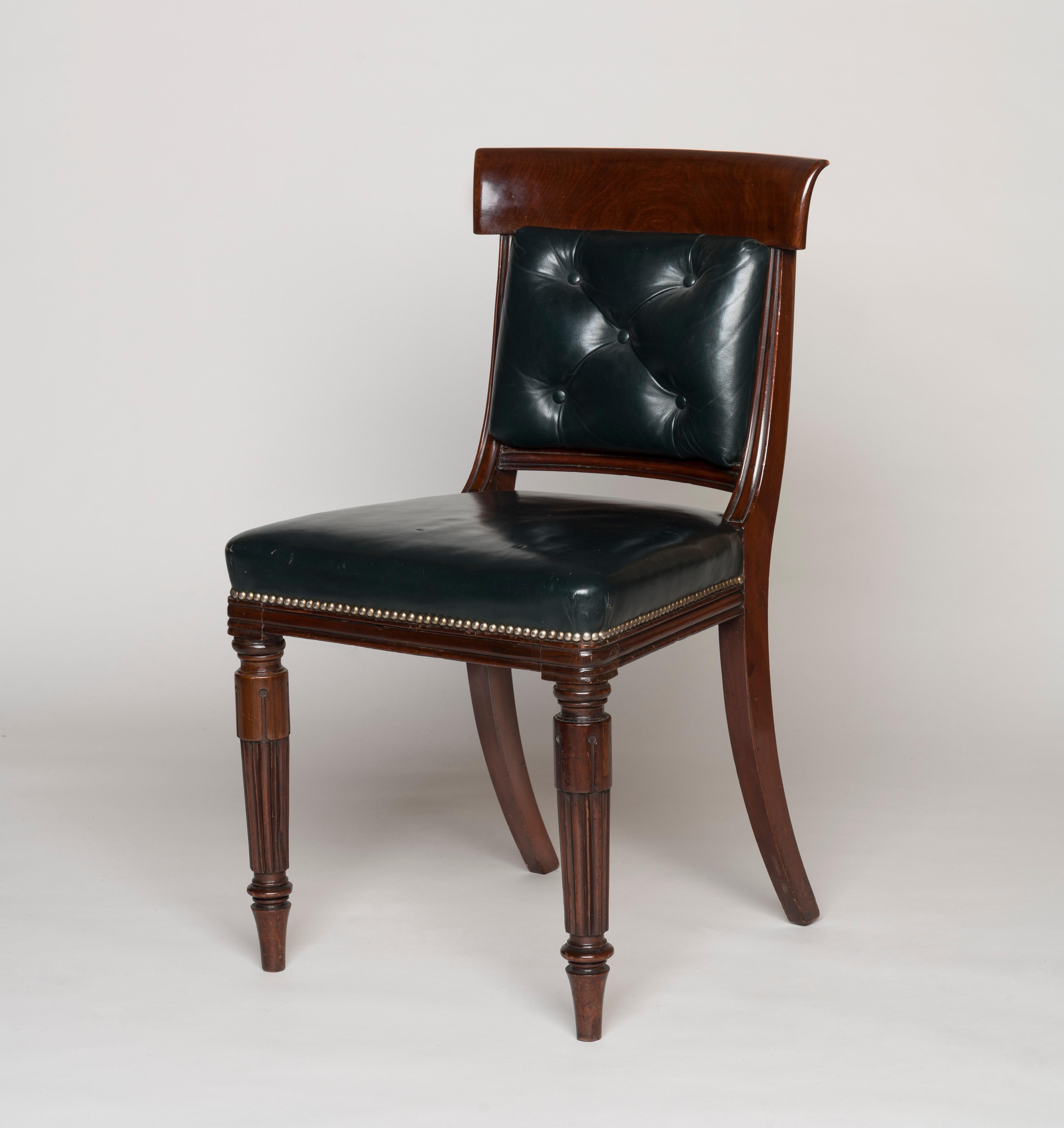 A Fine Set of 14 William IV Period Dining Chairs
From His Majesty's Ministerial Home Office

Constructed from mahogany, the chairs with turned and tapering reeded front legs terminating in lappet clasps, with buttoned leather padded backrests below