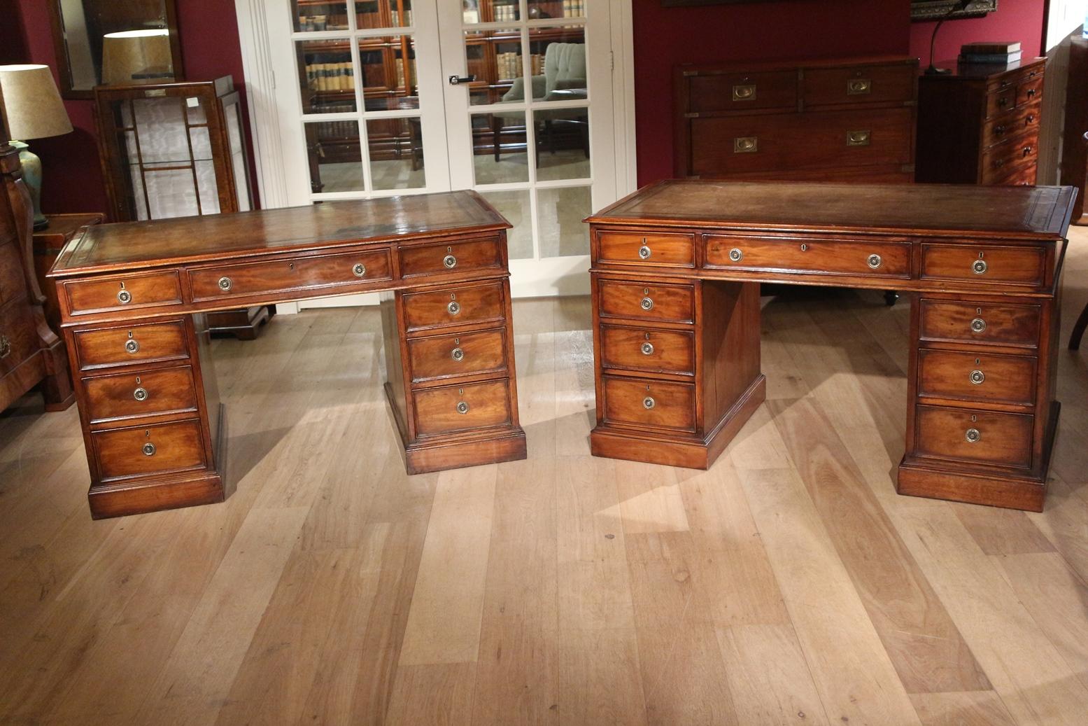 Set of antique exactly identical desks in beautiful original condition. Beautiful aged leather. The desks can be used in multiple configurations. Put together, for example, it becomes a large partner desk. Identical desks are rare. Only the height
