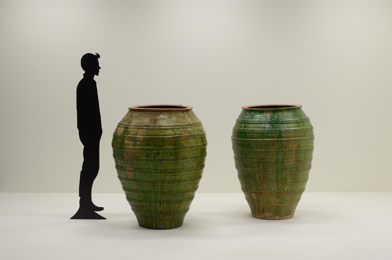 Set of 2 large early 16th century Tuscany vases, Italy. Rare and very large ceramic water vases with a green glaze. These vases were made in Tuscany Italy. Of course hand made and therefore not identical but unique. They have decorative lines all