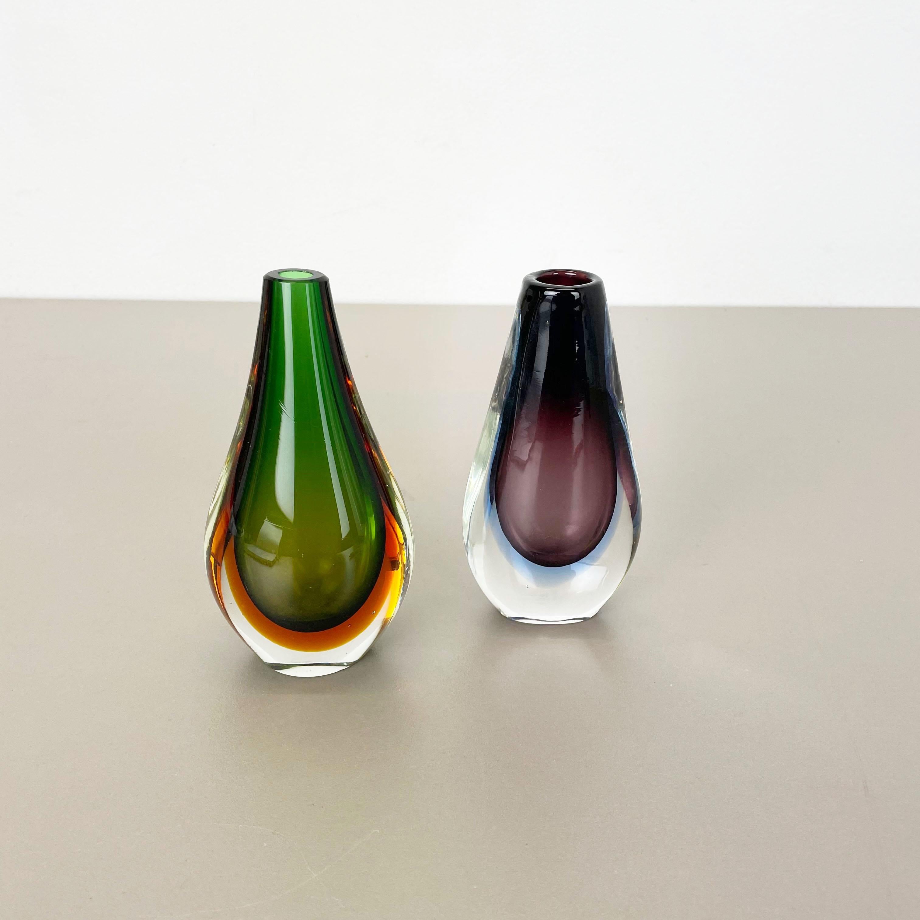 Article:

Murano glass vase set of 2


Origin:

Murano, Italy


Decade:

1970s



This original vintage glass vases set was designed and produced in the 1970s in Murano, Italy. It is made in Sommerso Technique and has a fantastic