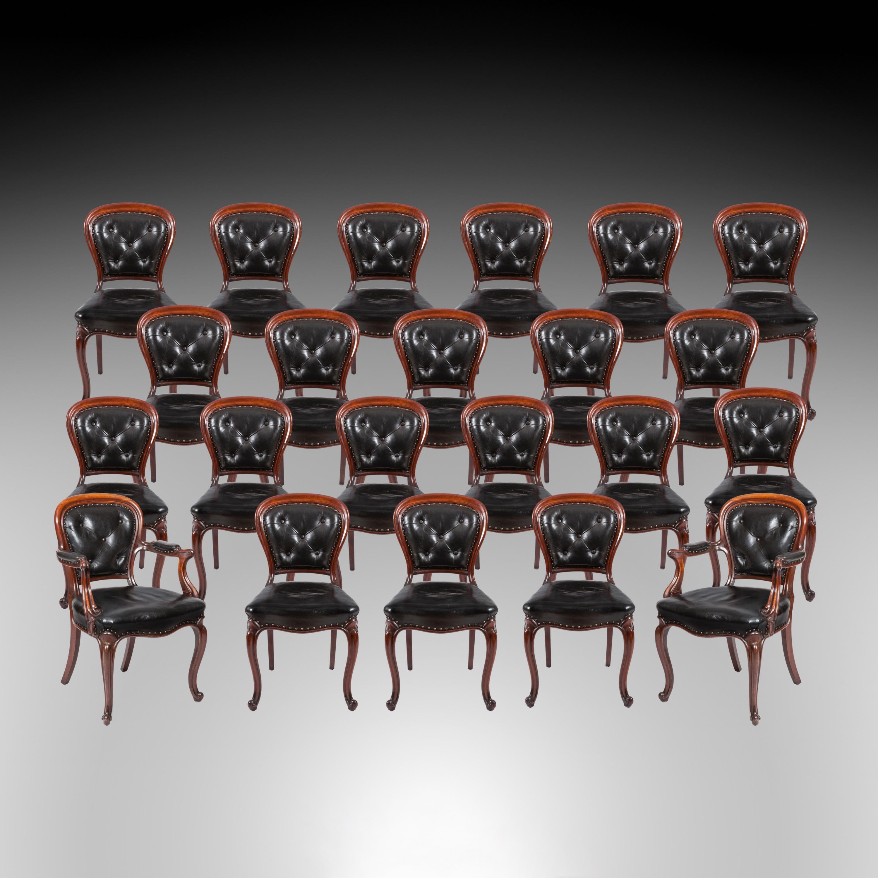 A Large Set of 22 mid-19th century Dining Chairs

Constructed from Honduran mahogany, prized for its strength and beauty, the set consisting of twenty side chairs and two armchairs; with cabriole legs, buttoned leather 'balloon' backs, and