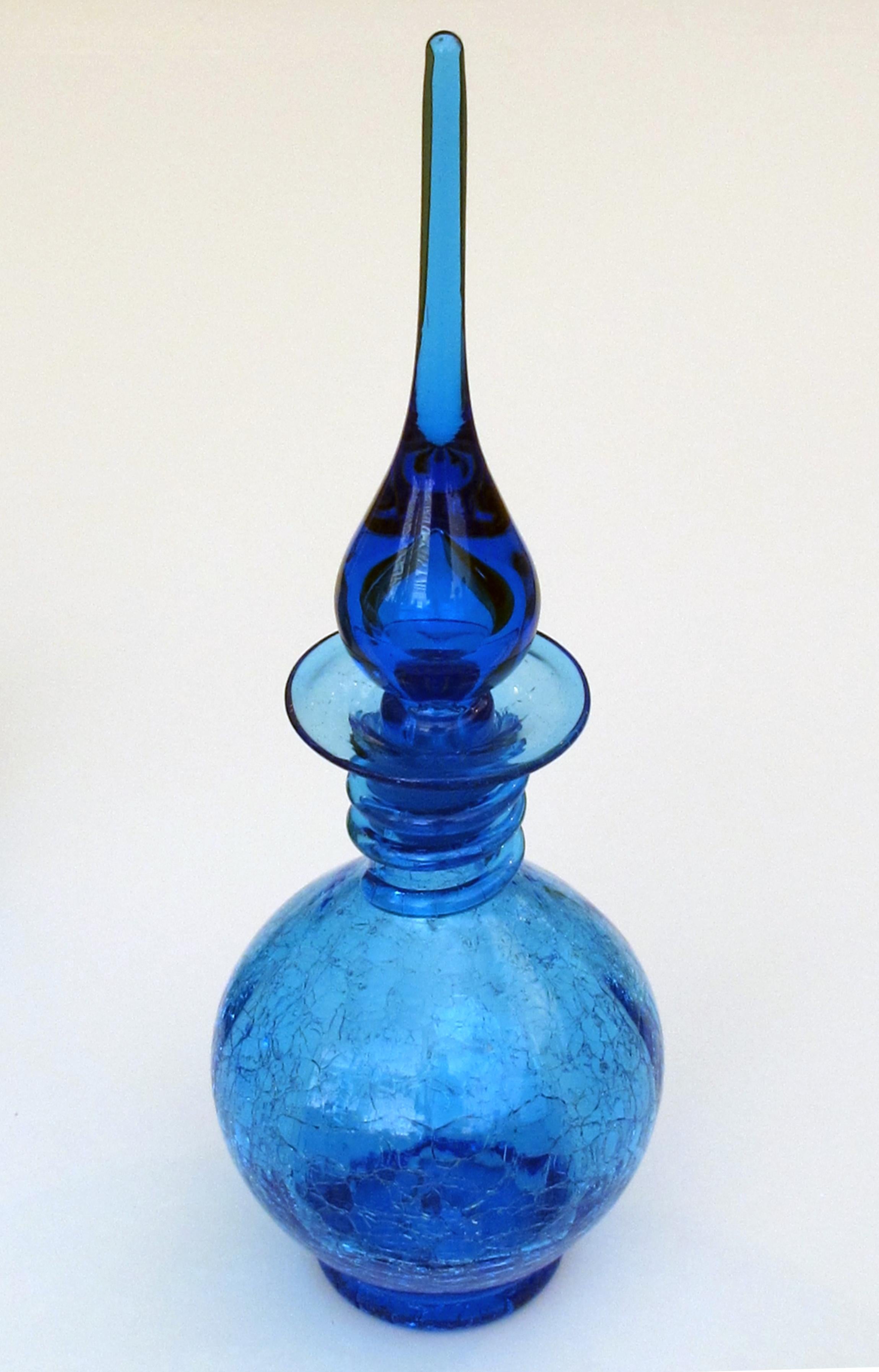 A rare set of 3 American 1960's art glass decanters by Joel Myers for Blenko Glassworks; each with onion-form stopper above bottle-form bodies in colors of blue and chartreuse; 2 decanters in iconic crackle glass; Joel Myers served as Director of