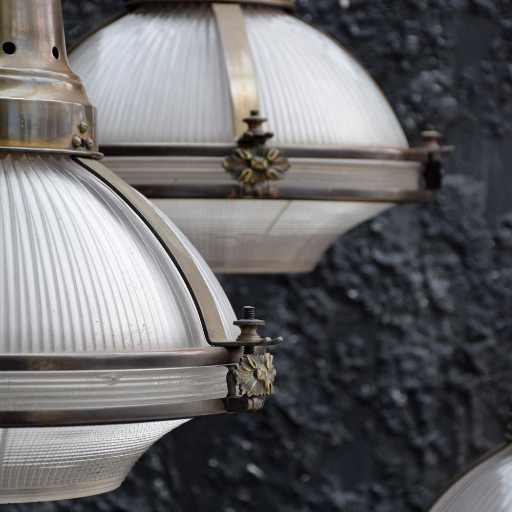 Hand-Crafted Rare set of 3 Holophane Glass Globe Pendant Lamps with brass fittings circa 1920