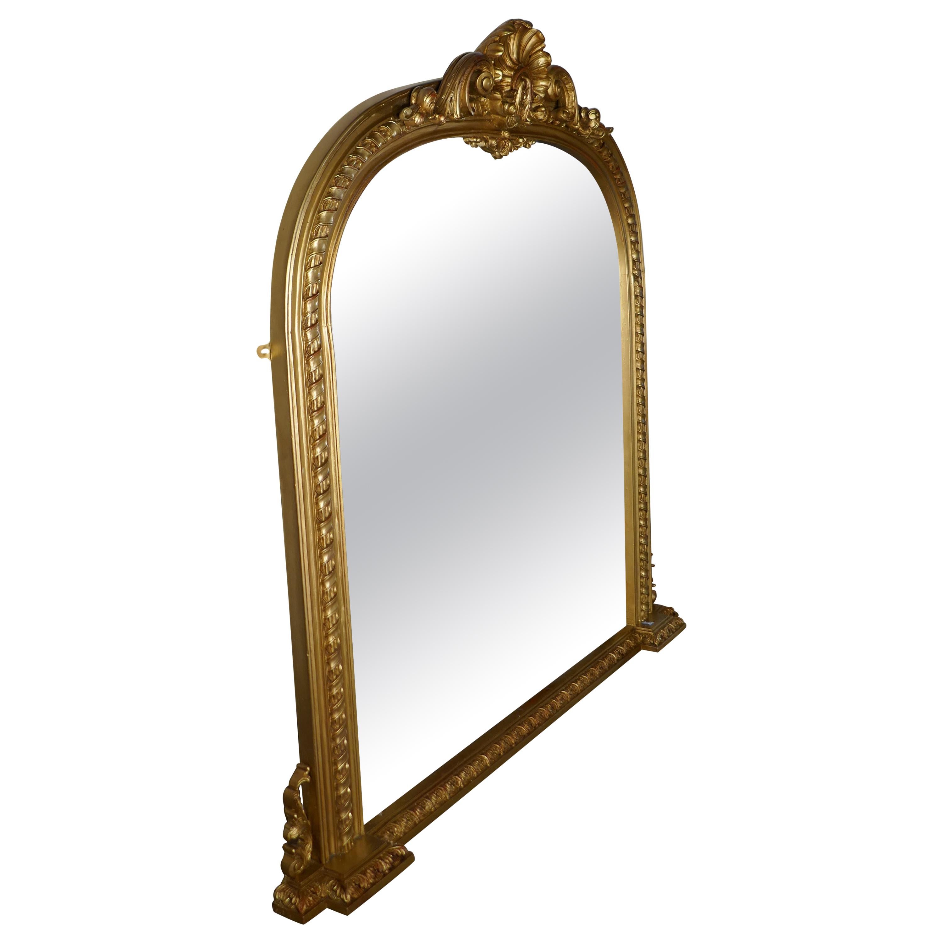Rare set of 3 large gilt arched Rococo over mantle mirrors 

These mirrors have beautiful Rococo gilt frames they are elaborately decorated with a shell motif at the top and swags of acanthus leaves and ribbons
The large arched frames are in good