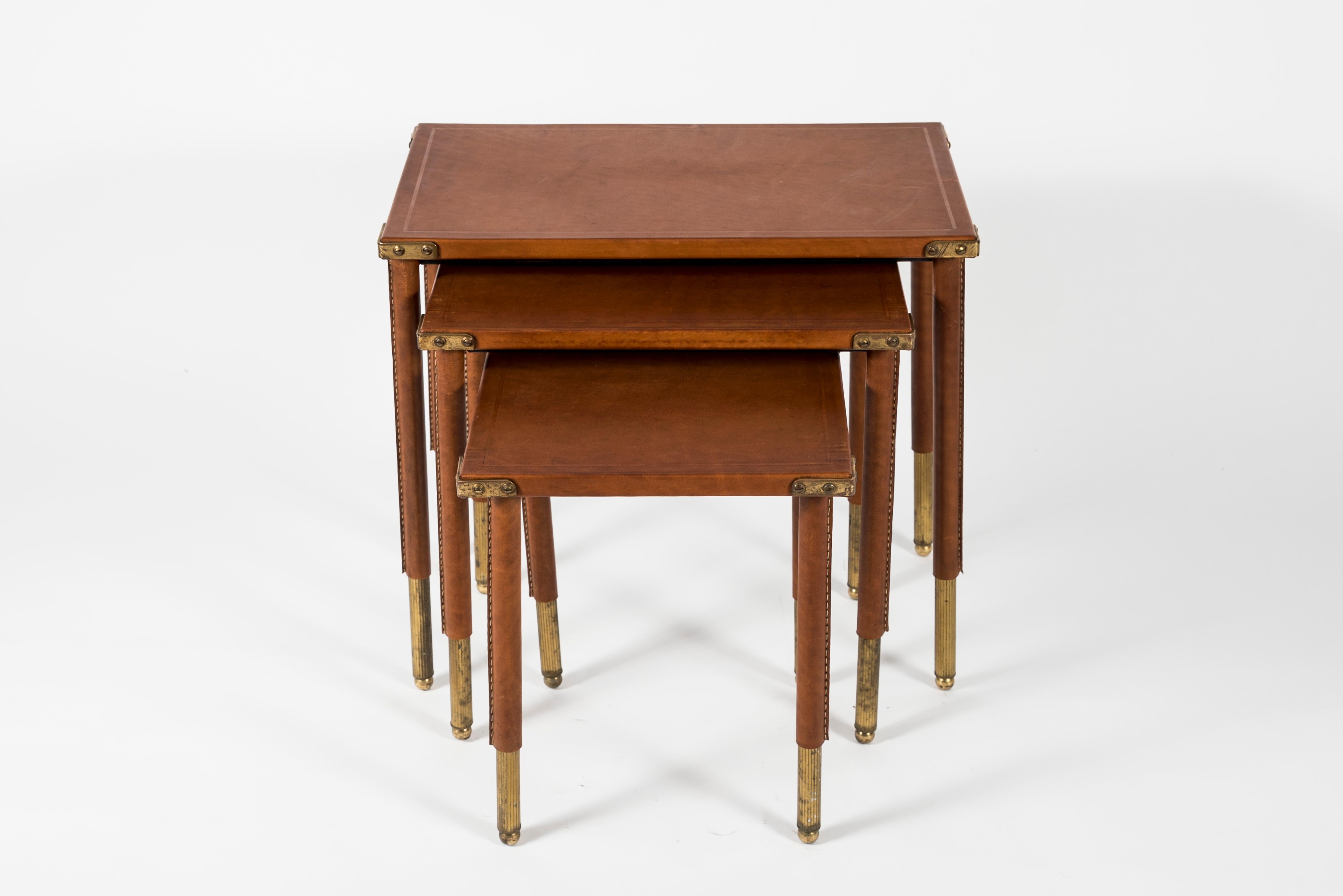 Set of nesting tables covered with stitched leather by Jacques Adnet
France,
1950
Dimensions are:
30 x 30 x 37 cm
30 x 30 x 42 cm
51 x 30 x 39 cm.