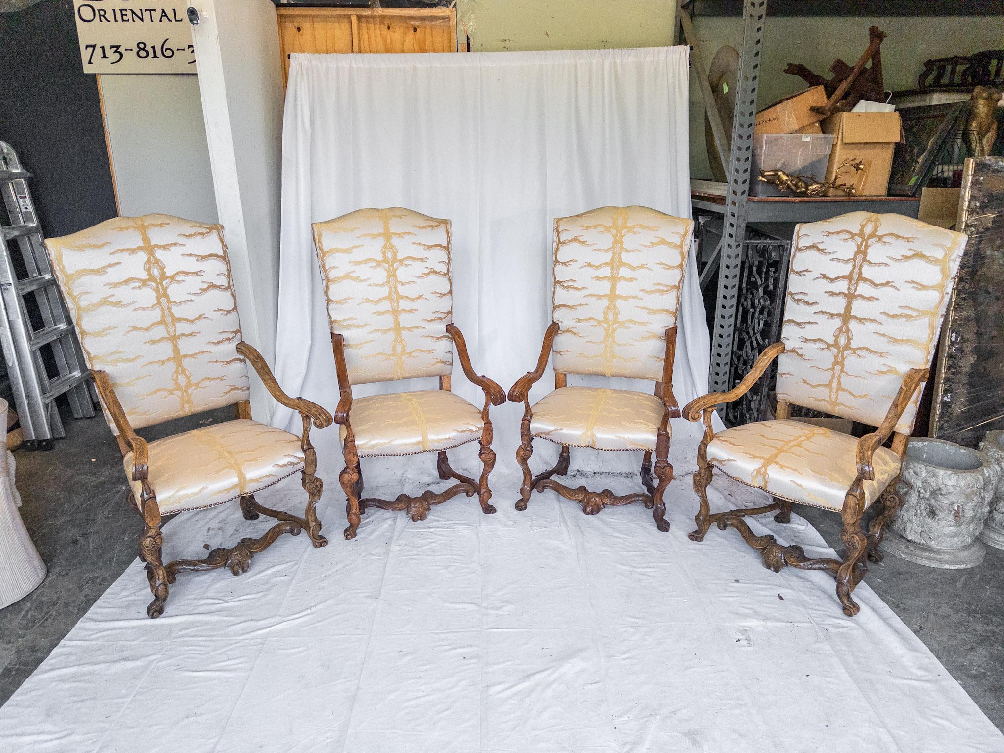 These 19th Century Italian Baroque Carved Walnut Tall Arm Chairs epitomize opulence and craftsmanship. Each chair stands as a testament to the mastery of the artisans of the era, with intricate carvings adorning every inch of the walnut frame. The