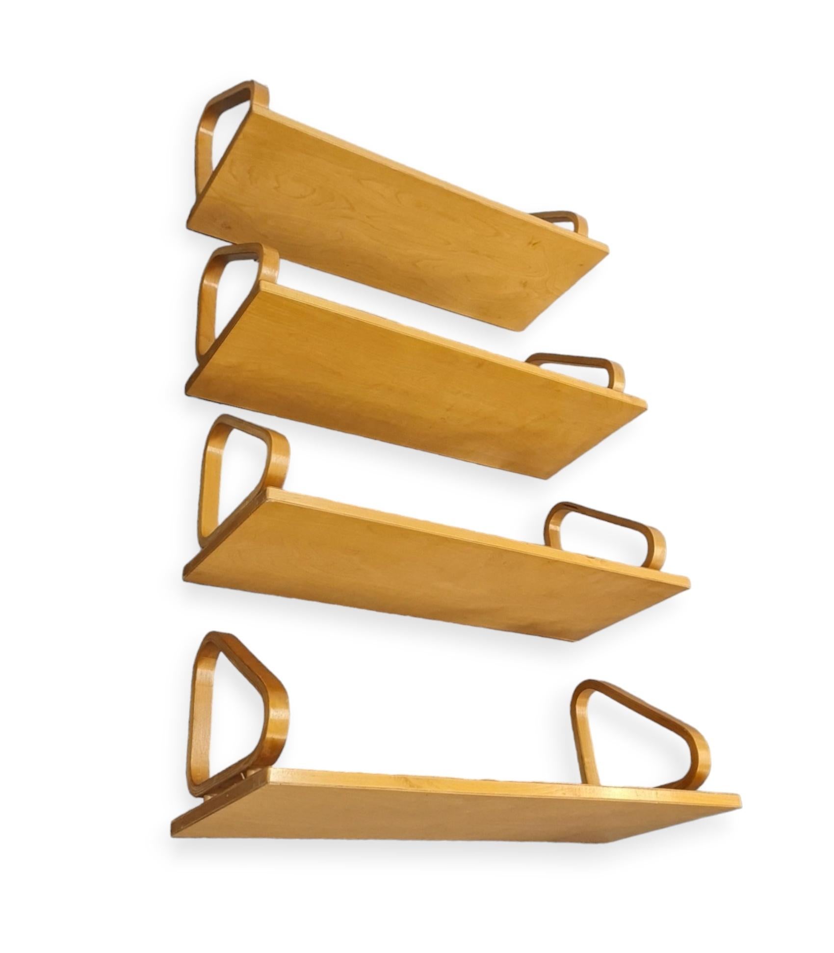 A beautiful set of 4 Alvar Aalto wall shelves model 112. These shelves with the pegs are much rarer than the normal ones, not to mention a set of four with the same patina and original condition. 

These minimalistic shelves have a genious light