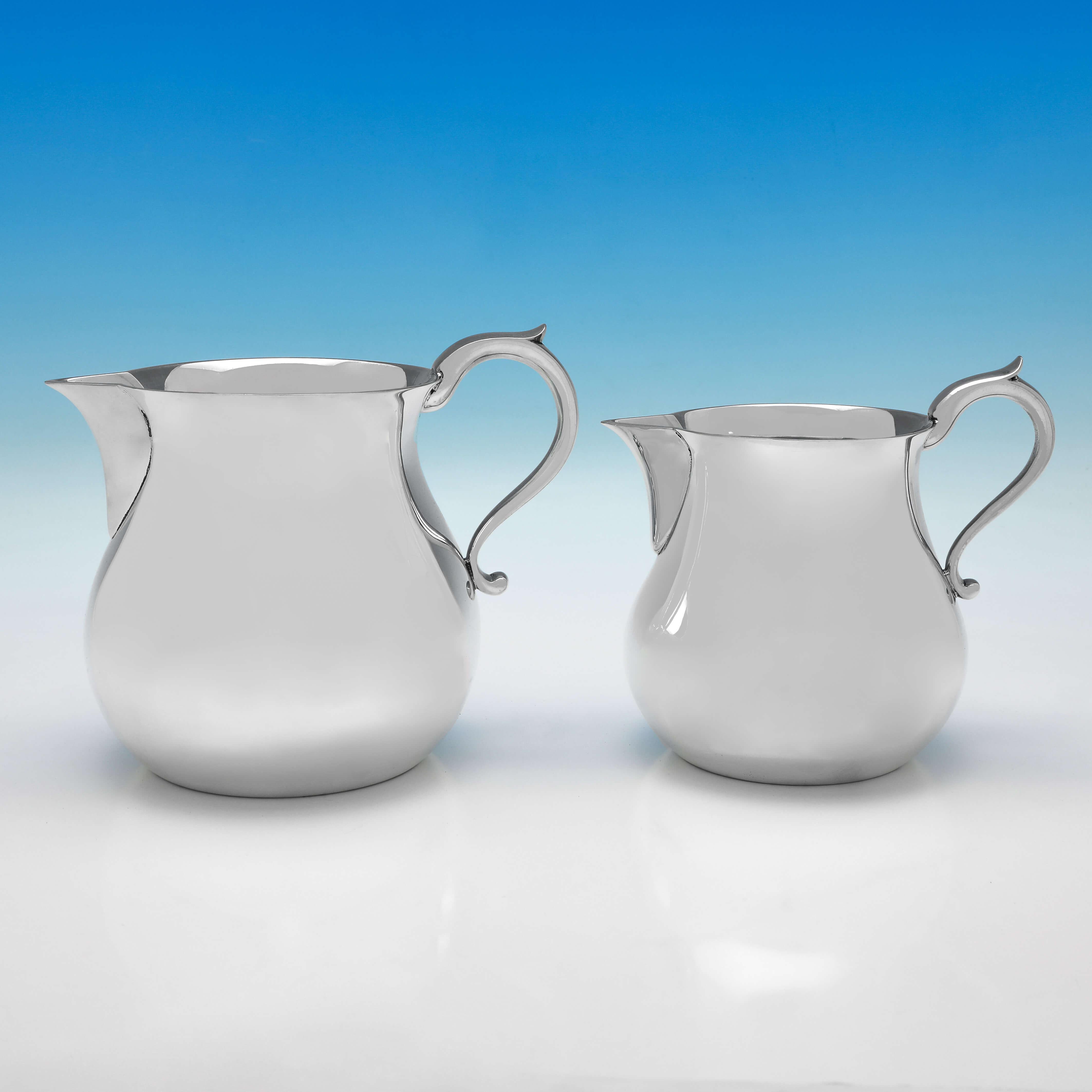 Hallmarked in London in 1978 by Edward Barnard & Sons, this very handsome and rare set of 4 graduating Sterling Silver Jugs, are plain in style, with scroll handles. 

The largest jug measures 6.5