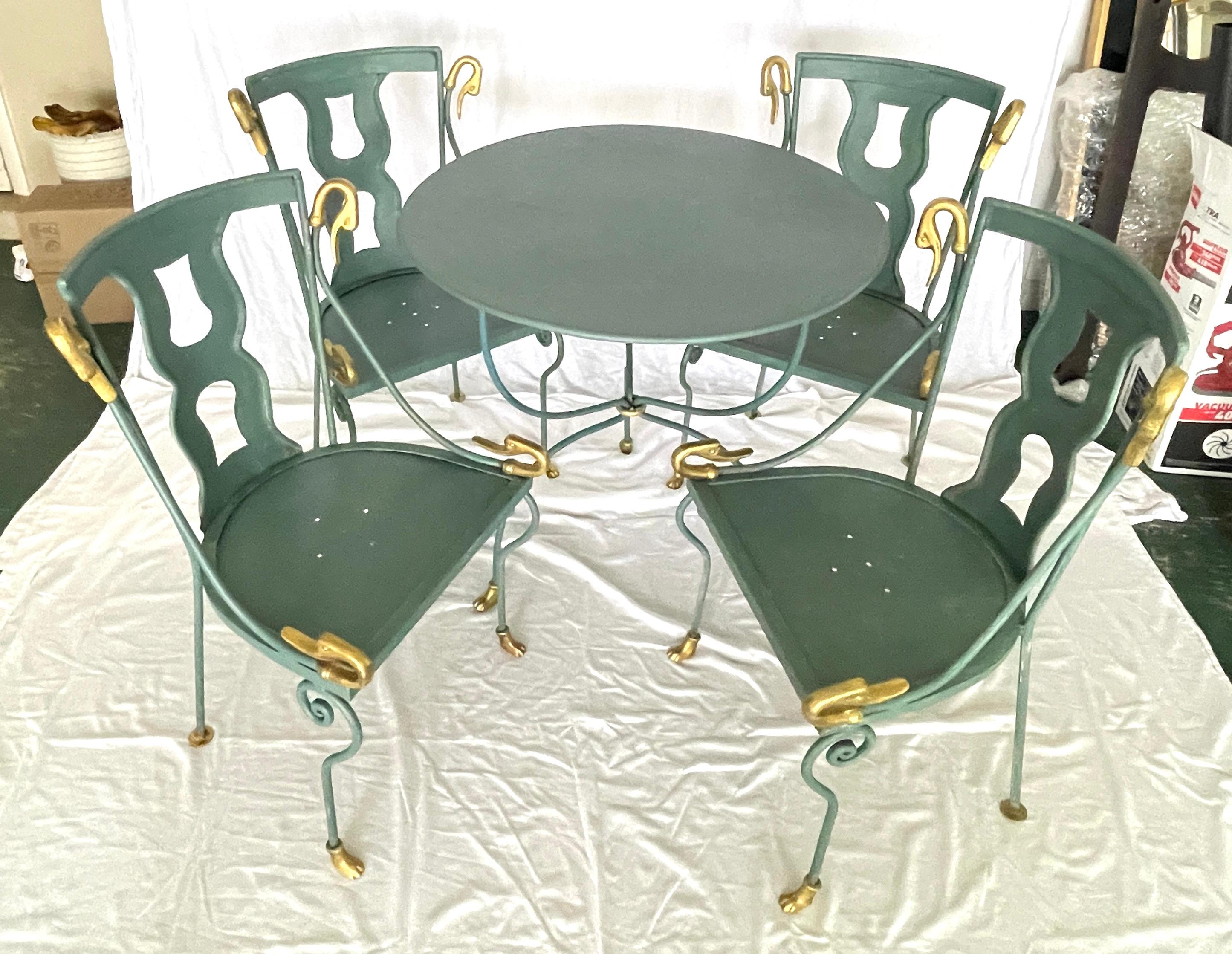 This is a Rare Set of  4 Swan Gondole Chairs & Table, in the manner of  Maison Jansen
Hollywood Regency, (1930-1950)
Painted in a Teal Green and Patinated made of  Iron and Brass, each with a shaped gondola  back , the scrolled  arms end with swan